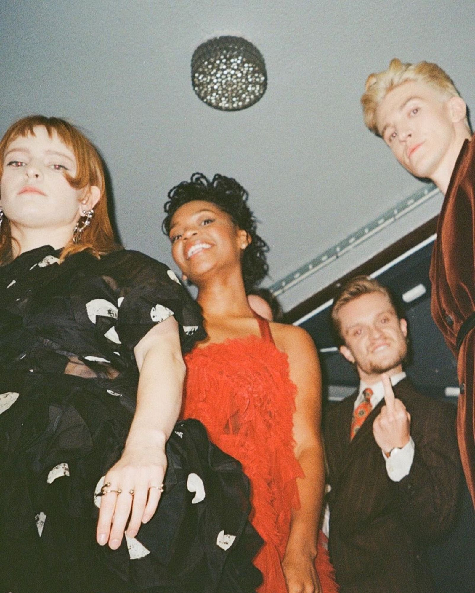 Tom Glynn-Carney, Ewan Mitchell, Bethany Antonia and Phia Saban at the #HOTDS2 London premiere. They’re looking down at the camera. Tom is giving the finger.