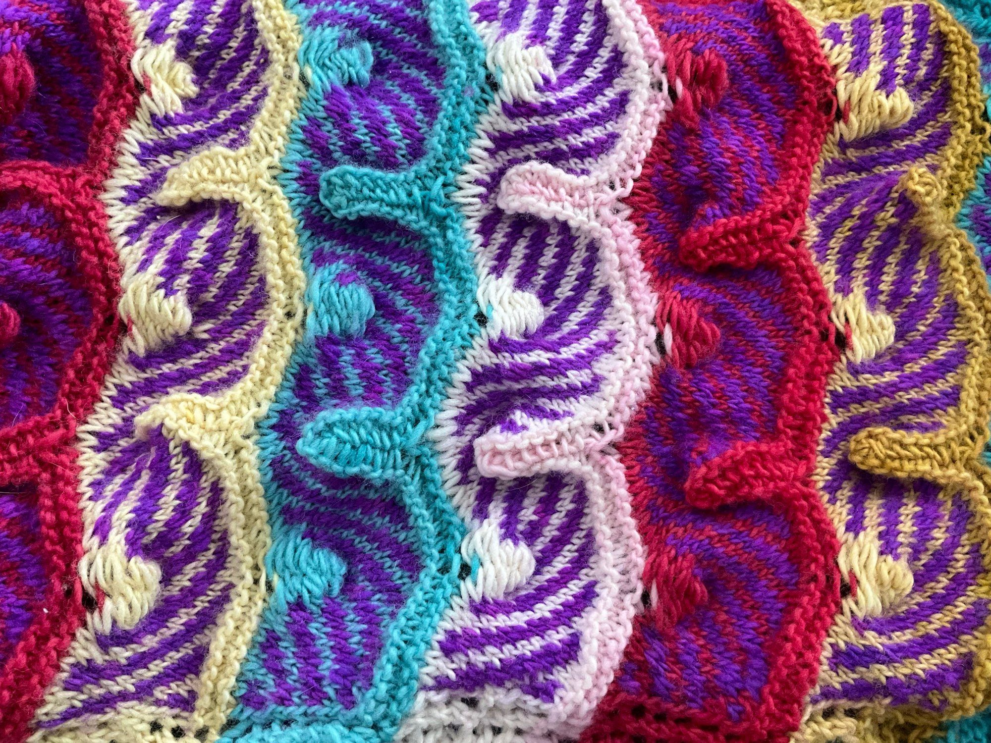 a swirly knitted fabric bit in red, yellow, pink, and white with purple swirls how the heck do i describe this?