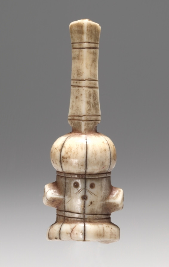 Carved out of ivory or wood in a variety of shapes, Chokwe whistles often bear miniature, stylized renderings of masks.  Cikunza, the "patron saint" of the boys' initiation into manhood, is depicted with a pointed extension imitating the horn of a road antelope, symbolizing the fertility spirit.  Typically such whistles were used by men during the hunt to communicate with their co-hunters and to call their dogs.  They were either worn attached to a string as a necklace or tied to a spear.