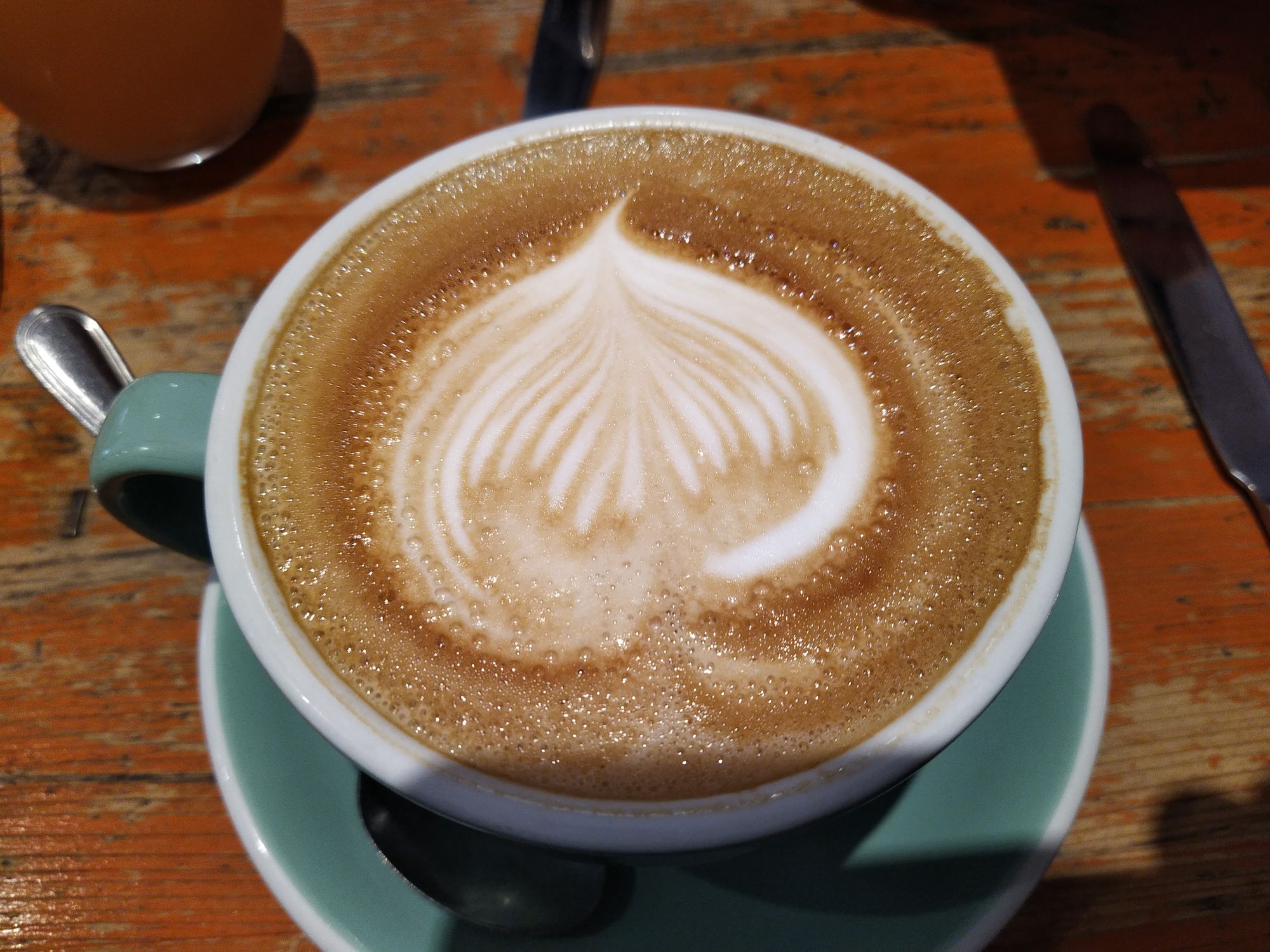 Latte art in the shape of an onion. Or maybe a heart, upside down.