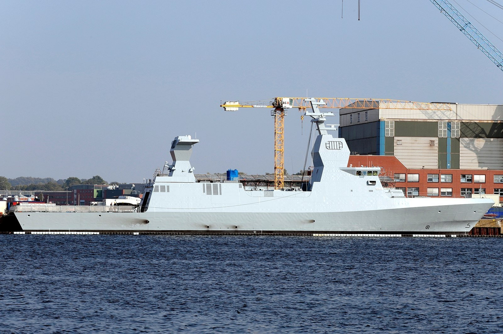 Israeli Naval Service Sa'ar 6 corvette warships seen docked at a ThyssenKrupp Marine Systems (TKMS) dock in Kiel, Germany (Photo 3) and firing missiles while at sea (Photo 4). Photo credits: Marco Kuntzsch/Wikimedia Commons (Photo 3) and IDF Spokesperson Unit (Photo 4) 
