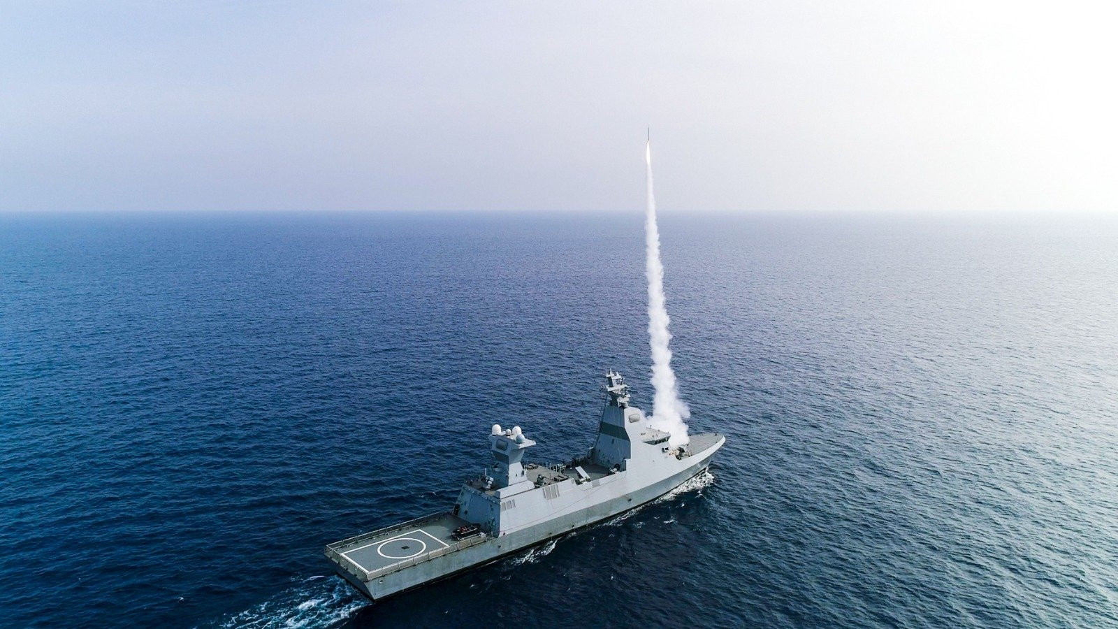 Israeli Naval Service Sa'ar 6 corvette warships seen docked at a ThyssenKrupp Marine Systems (TKMS) dock in Kiel, Germany (Photo 3) and firing missiles while at sea (Photo 4). Photo credits: Marco Kuntzsch/Wikimedia Commons (Photo 3) and IDF Spokesperson Unit (Photo 4) 
