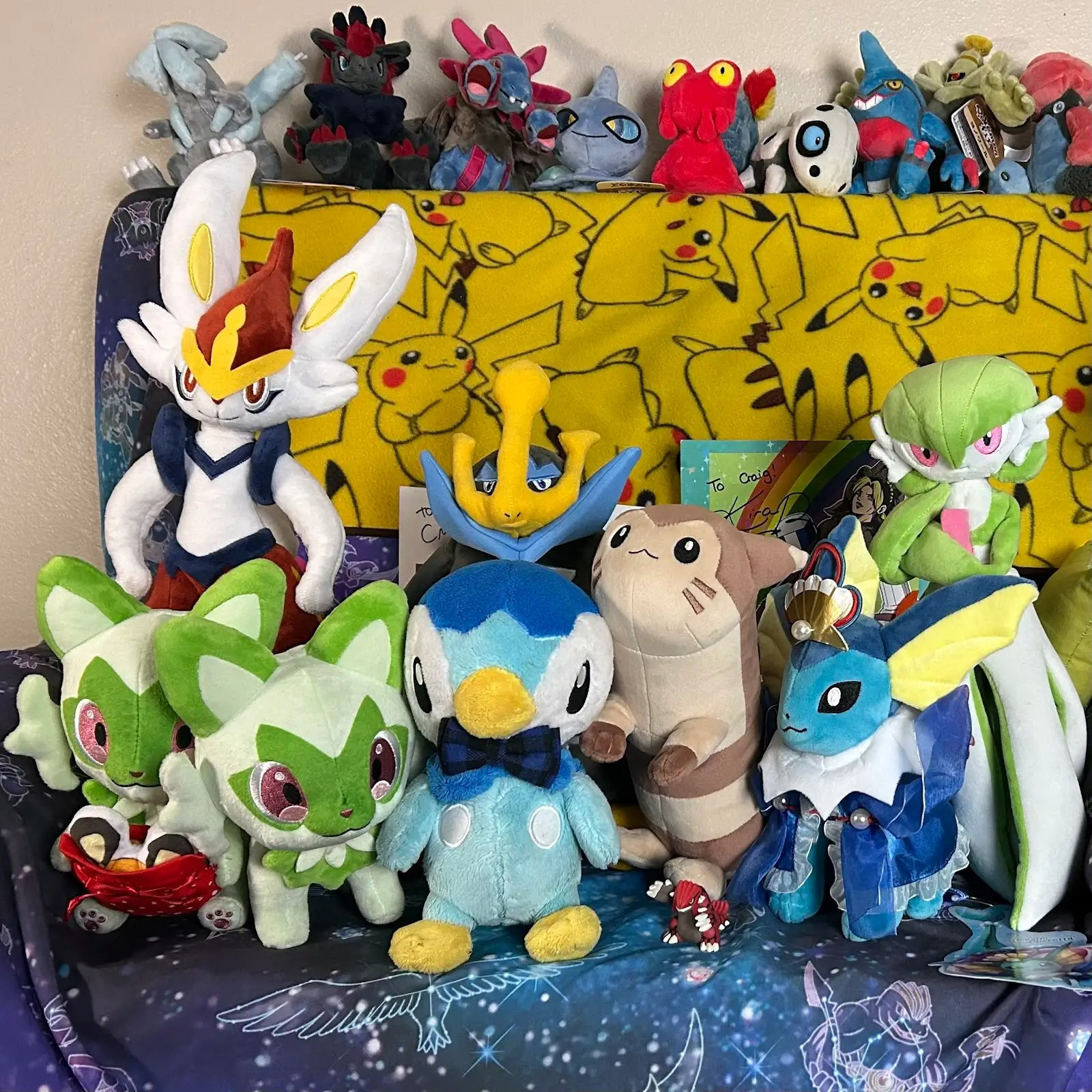 Me in the center, along with Long Boi the co-host Furret, Trish the camera woman Gardevoir, my brother Bonaparte, Julio the video editing Cinderace and Pringle and Jingle, our Sprigatito twins. Greg the Groudon was a former member so we have a figure in his place.