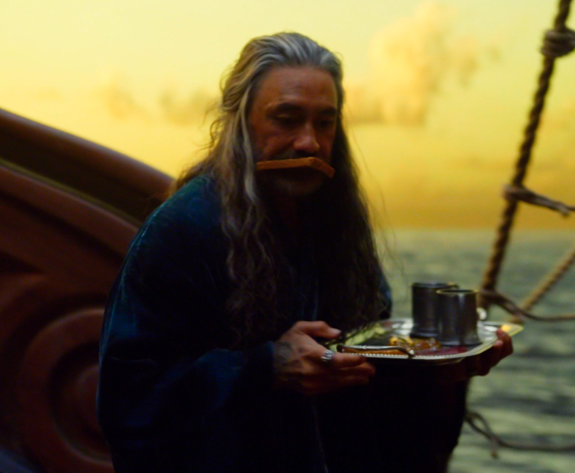 Screenshot of Ed holding the breakfast tray, toast in his mouth
