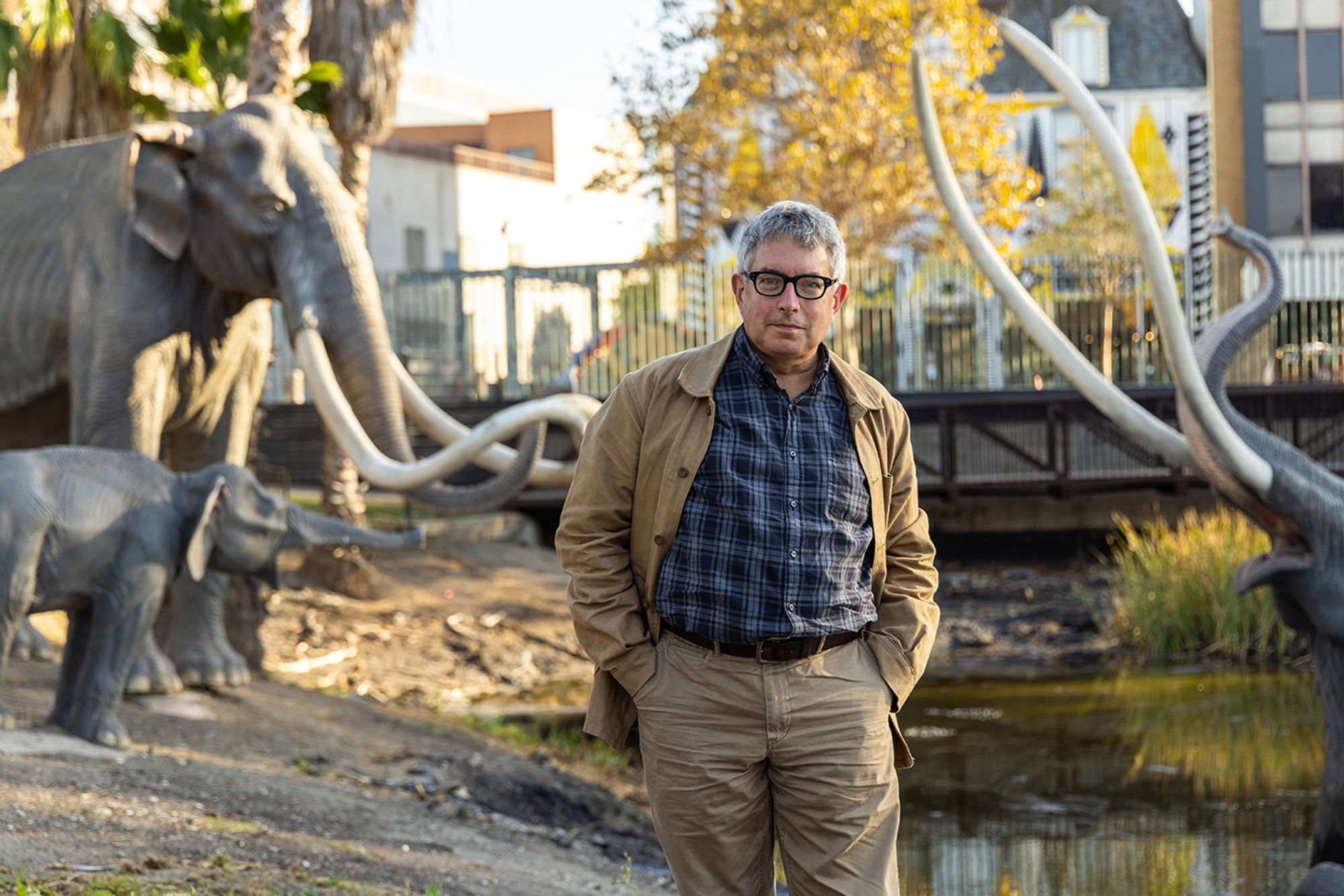 Conceptual Artist Mark Dion photographed amidst the iconic Lake Pit Family at La Brea Tar Pits & Museum.