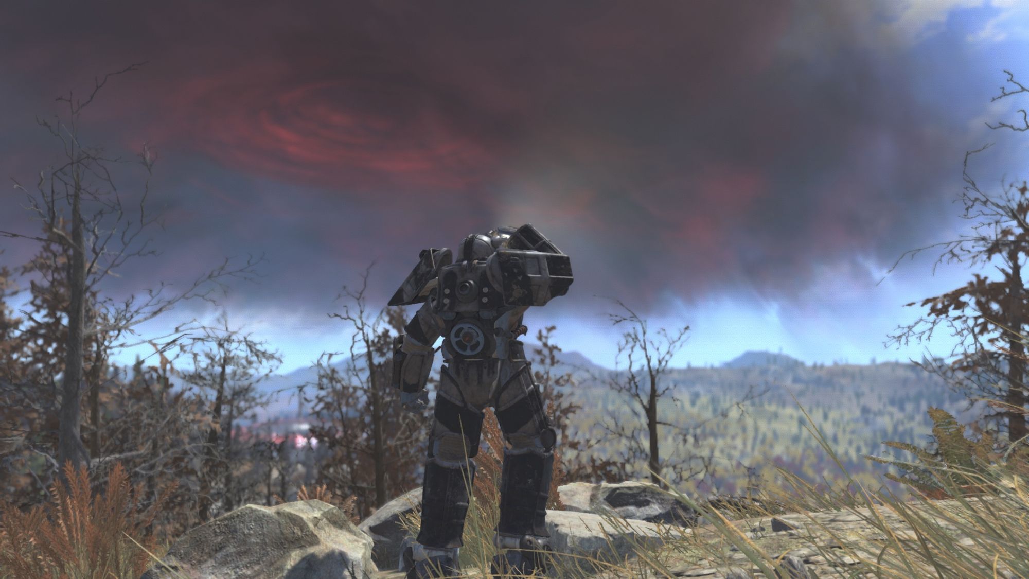 Screenshot from the game Fallout 76 centring on the player character wearing a suit of Union power armour in Devilish Paint. The player character is looking out over the recently discovered Shenandoah Valley. A large red tinted storm lies in the sky.