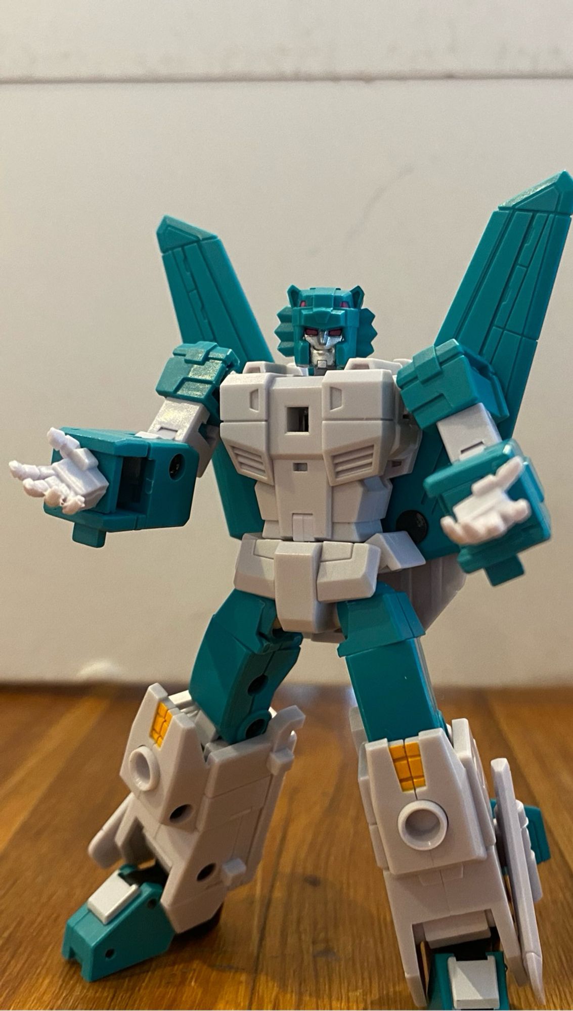 Image of the 3rd party action figure of the Transformers Breastforce character Leozack by Iron Factory. Leozack is holding his arms out in front with palms open to the sky. Leozack is smirking at the camera.