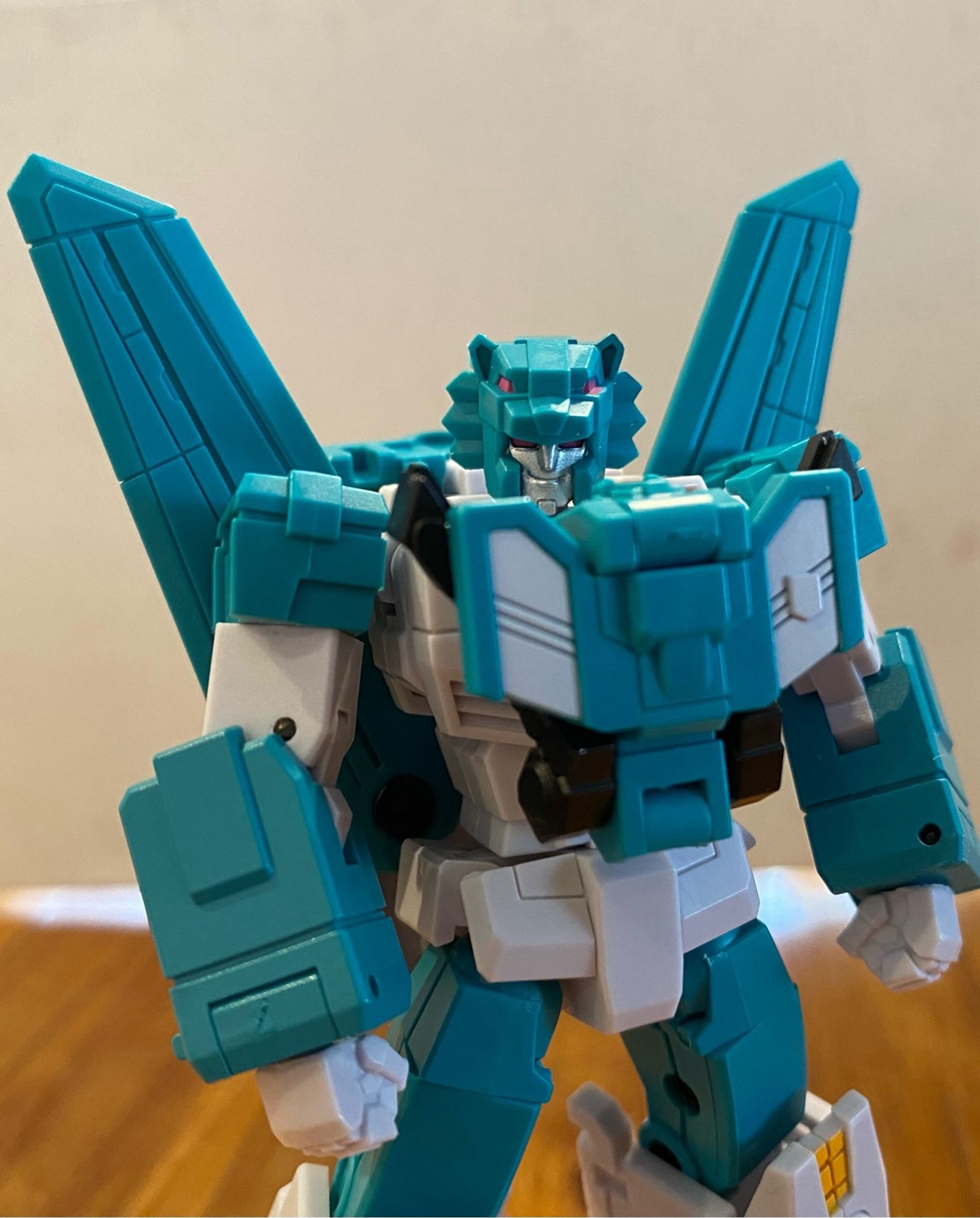 Image of the 3rd party action figure of the Transformers Breastforce character Leozack by Iron Factory. Leozack is holding his arms at his side. Leozack is smirking at the camera.