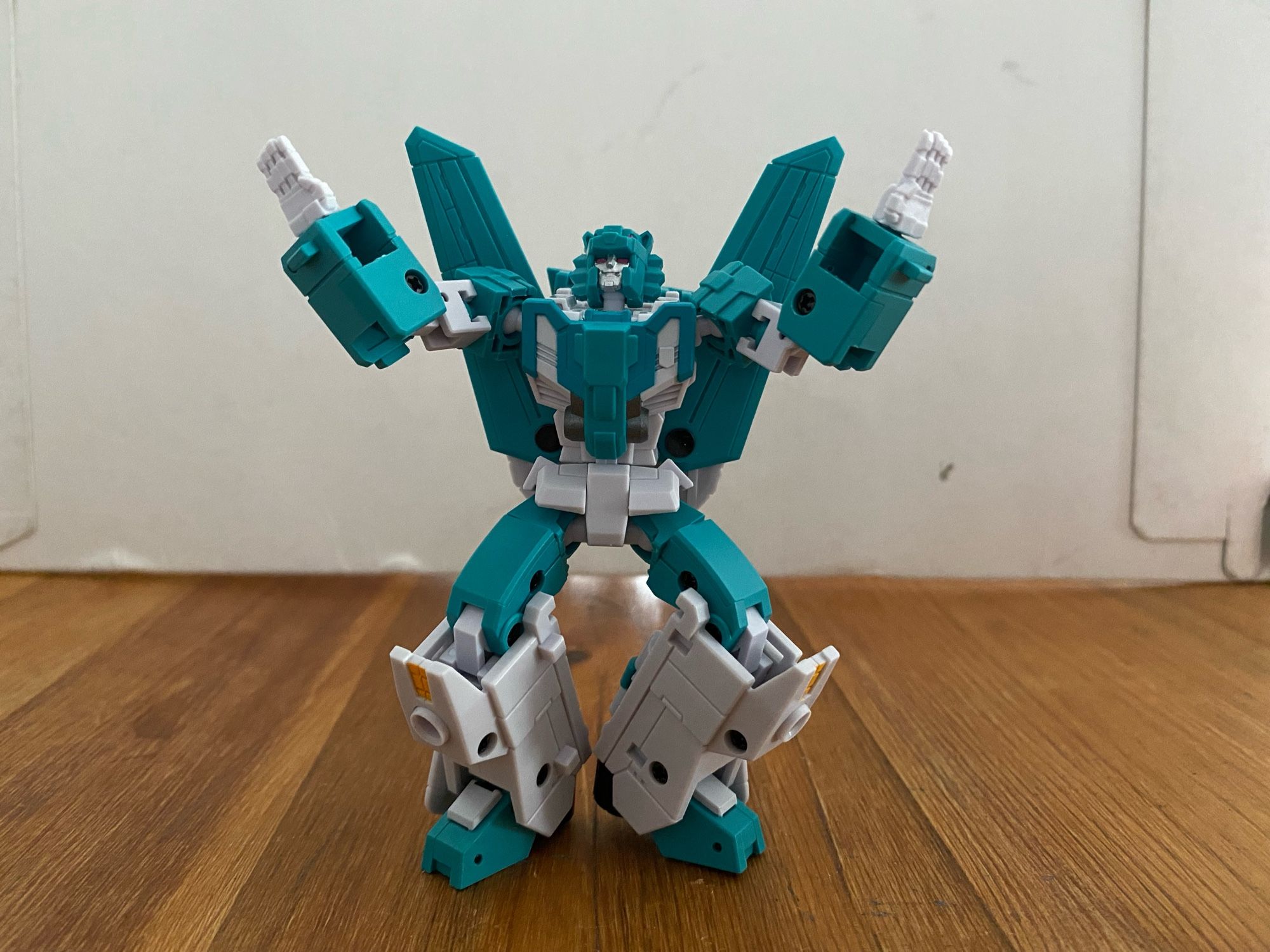 Image of the 3rd party action figure of the Transformers Breastforce character Leozack by Iron Factory. Leozack with both palms flat and outstretched with arms akimbo and pointed up, heels together with both legs bent at the knee, looking up and off camera.