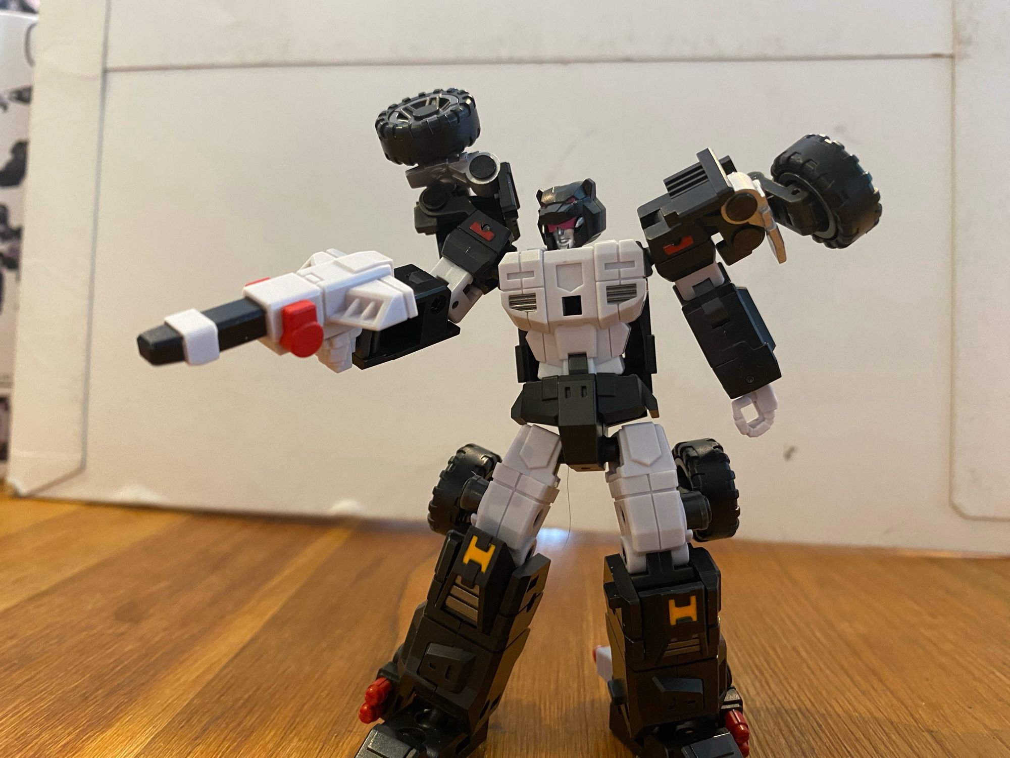 Image of the 3rd party action figure of the Transformers Breastforce character Jallguar a.k.a Claw of Ose by Iron Factory. Jallguar is holding his firearm in his right hand, pointed off camera.