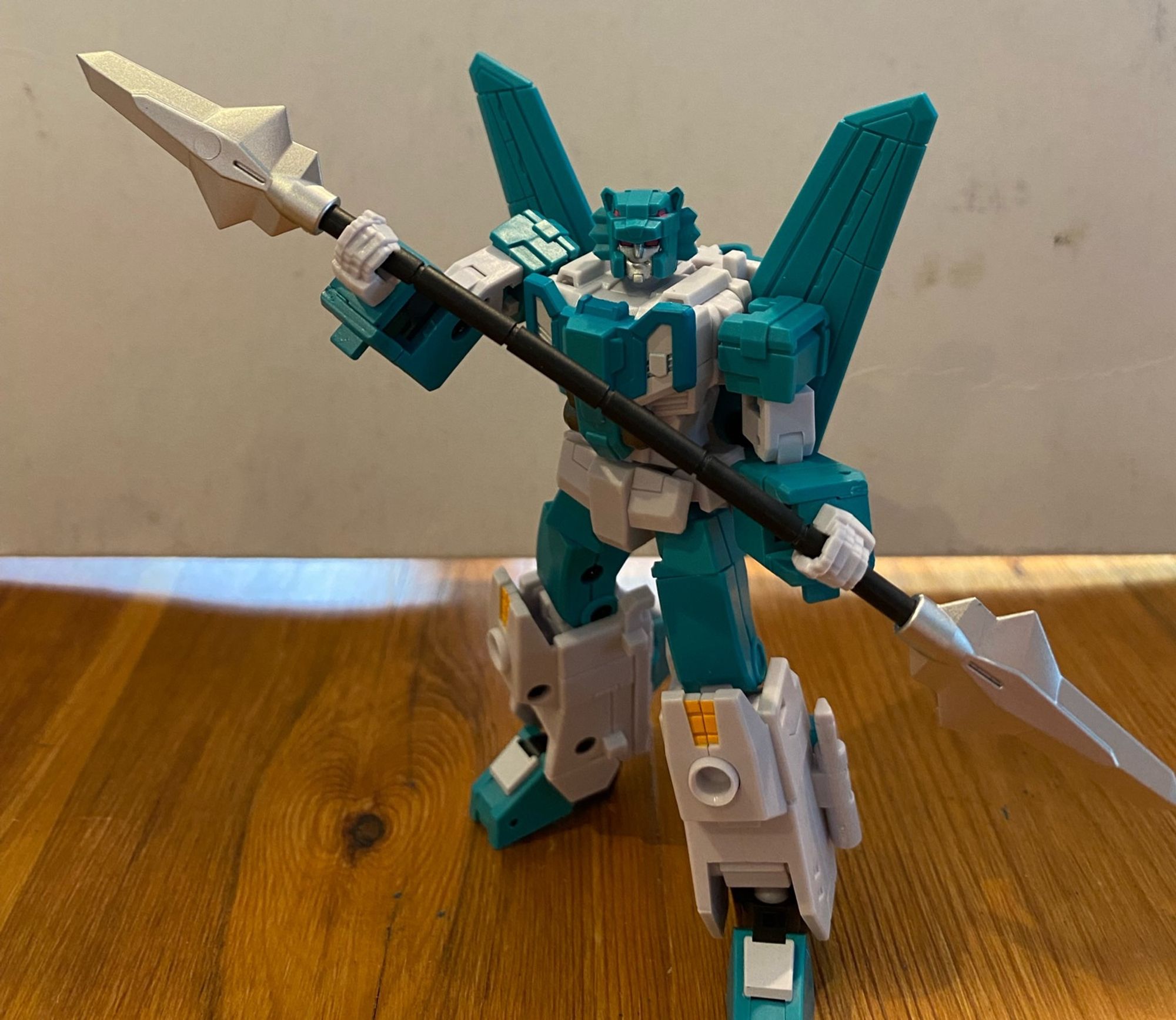 Image of the 3rd party action figure of the Transformers Breastforce character Leozack by Iron Factory. Leozack is holding a double ended spear and facing the camera.