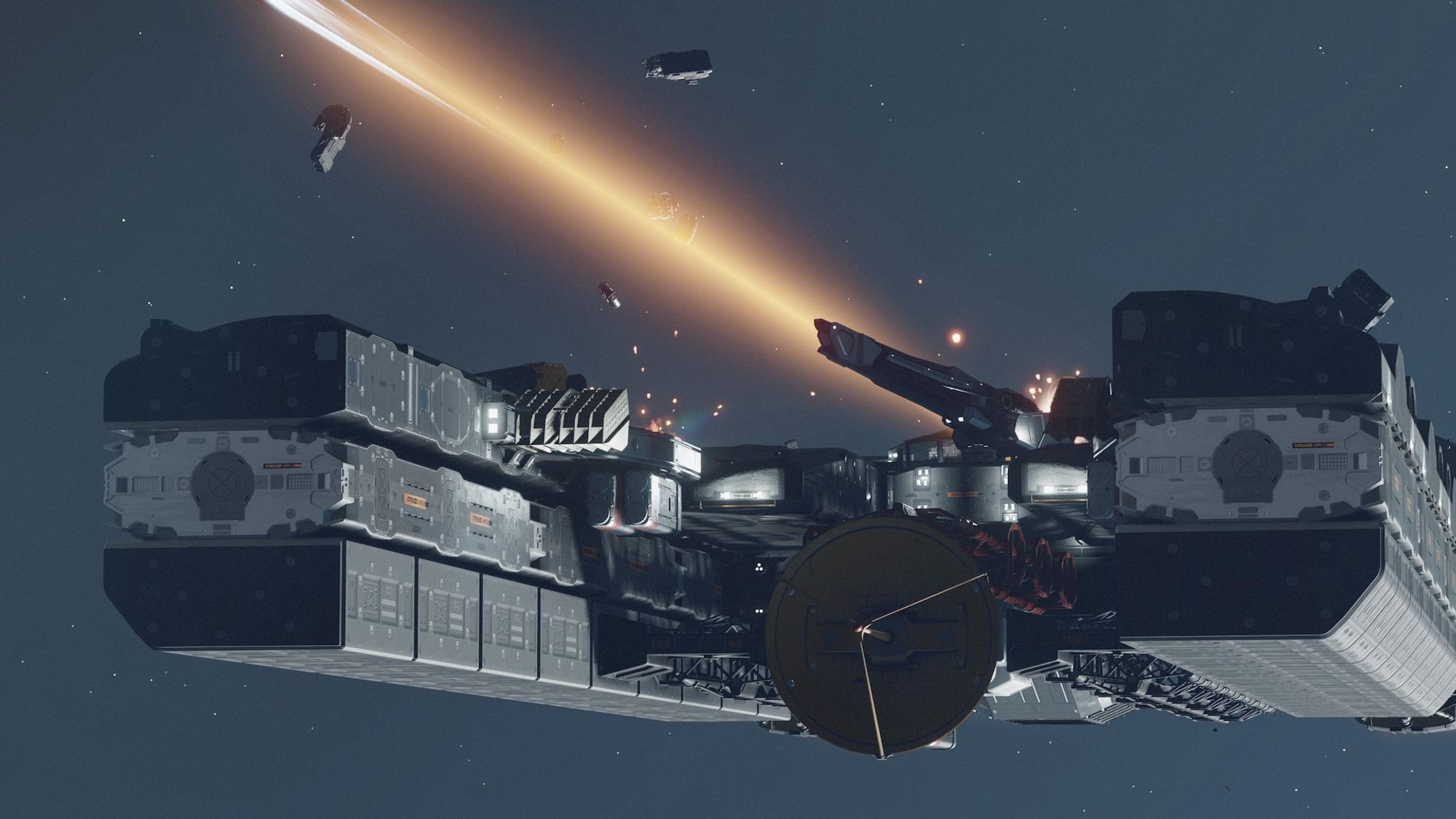 Screenshot from the game Starfield centring on a large grey starship flying through space from a low three-quarter frontal view. There’s a large energy weapon mounted to the top of the ship and firing off screen.