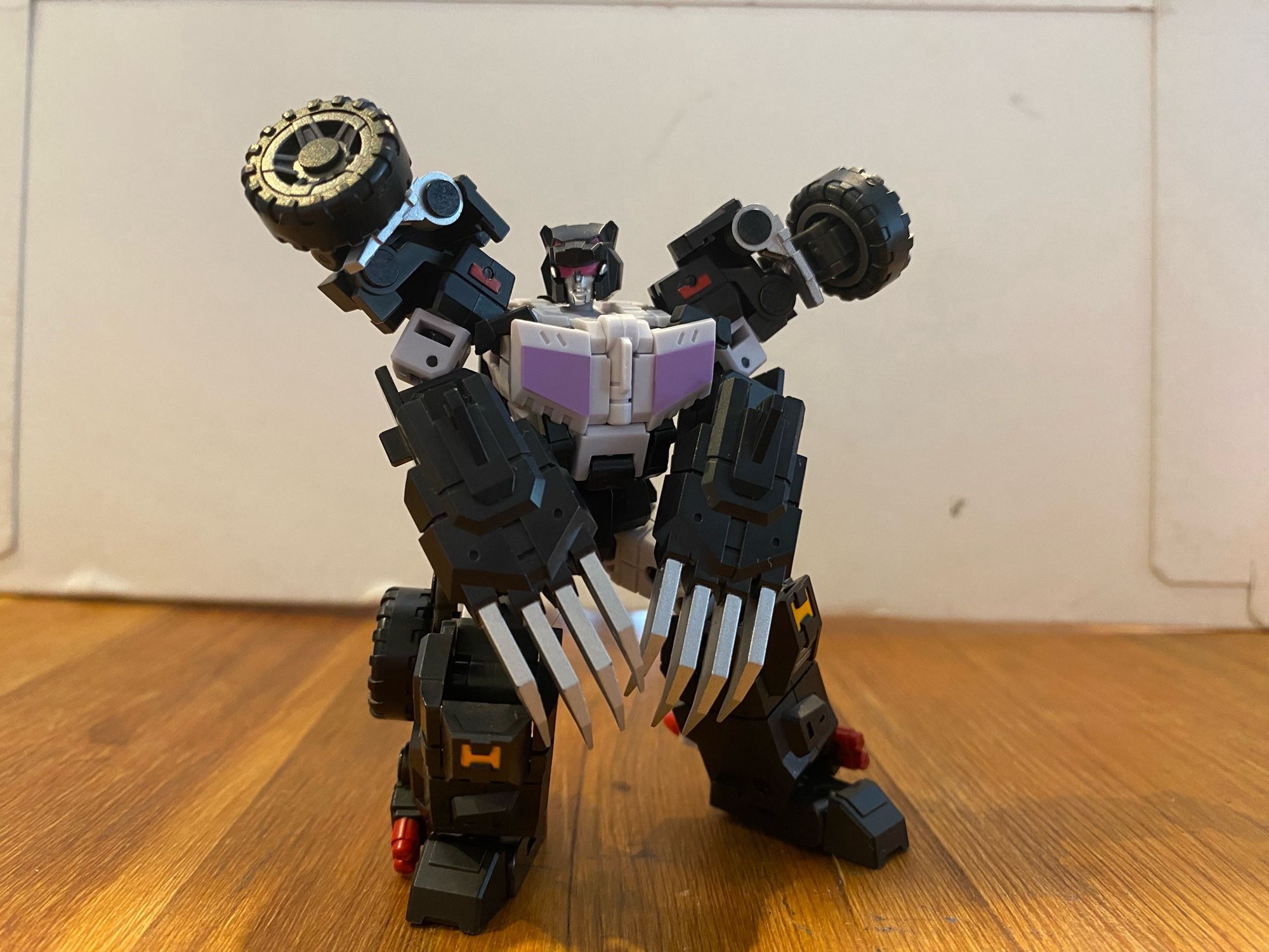 Image of the 3rd party action figure of the Transformers Breastforce character Jallguar a.k.a Claw of Ose by Iron Factory. Jallguar is squatting with large clawed gloves on each hand and looking at the camera.