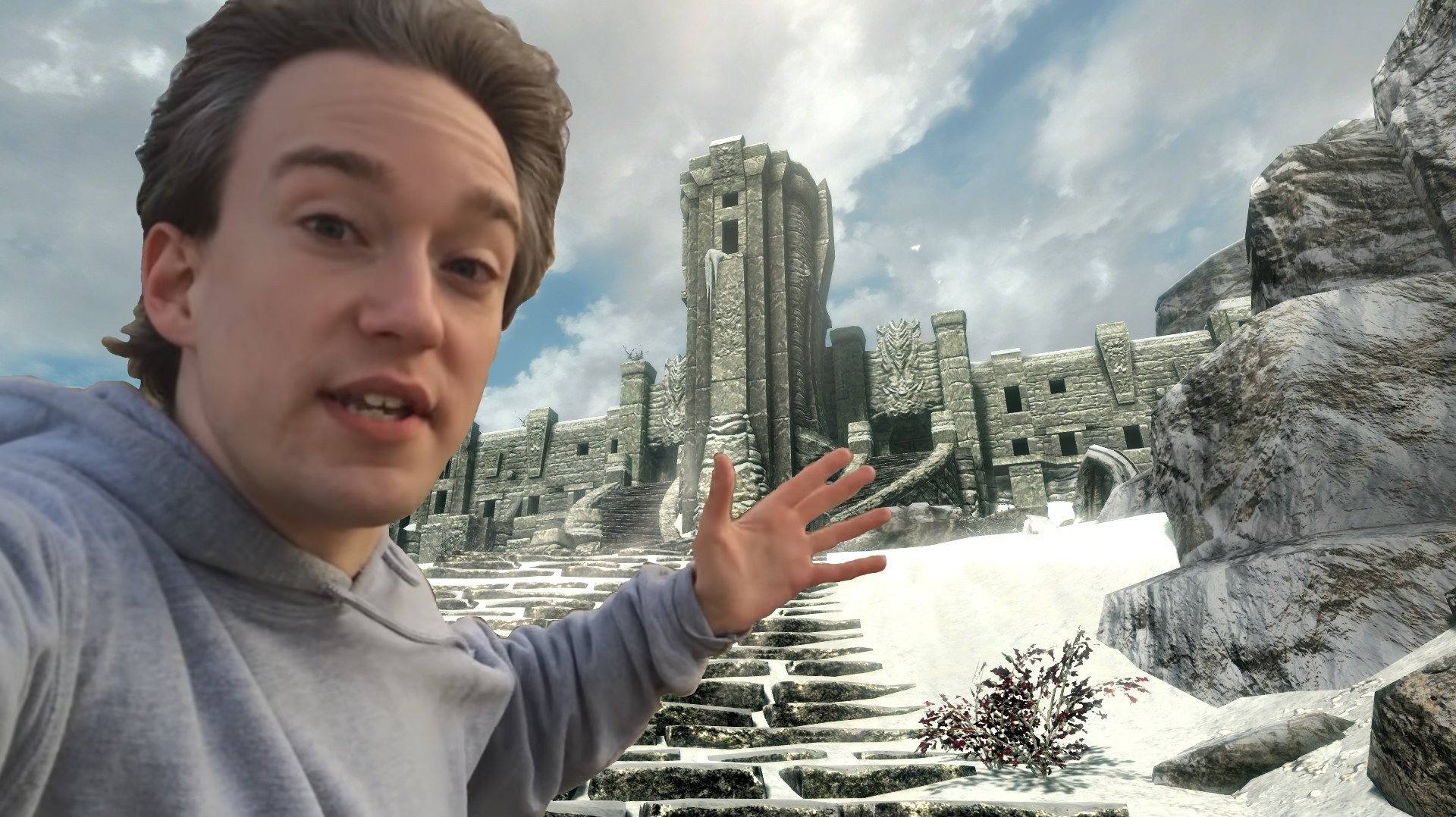 a screenshot of high hrothgar on the throat of the world from skyrim with a picture of tom scott photoshopped into it as if he is presenting it