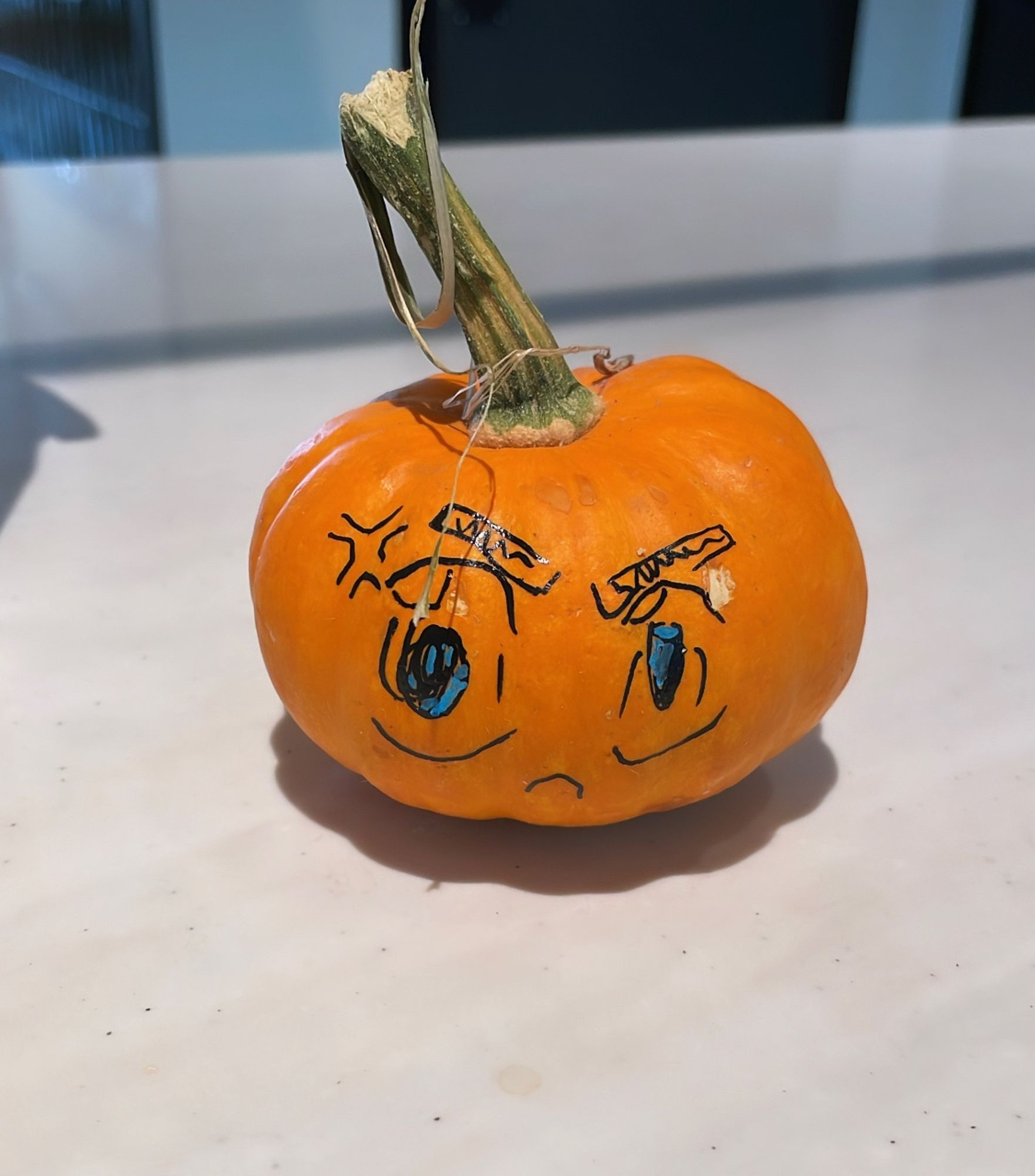 Tiny pumpkin with cute angry anime face drawn on