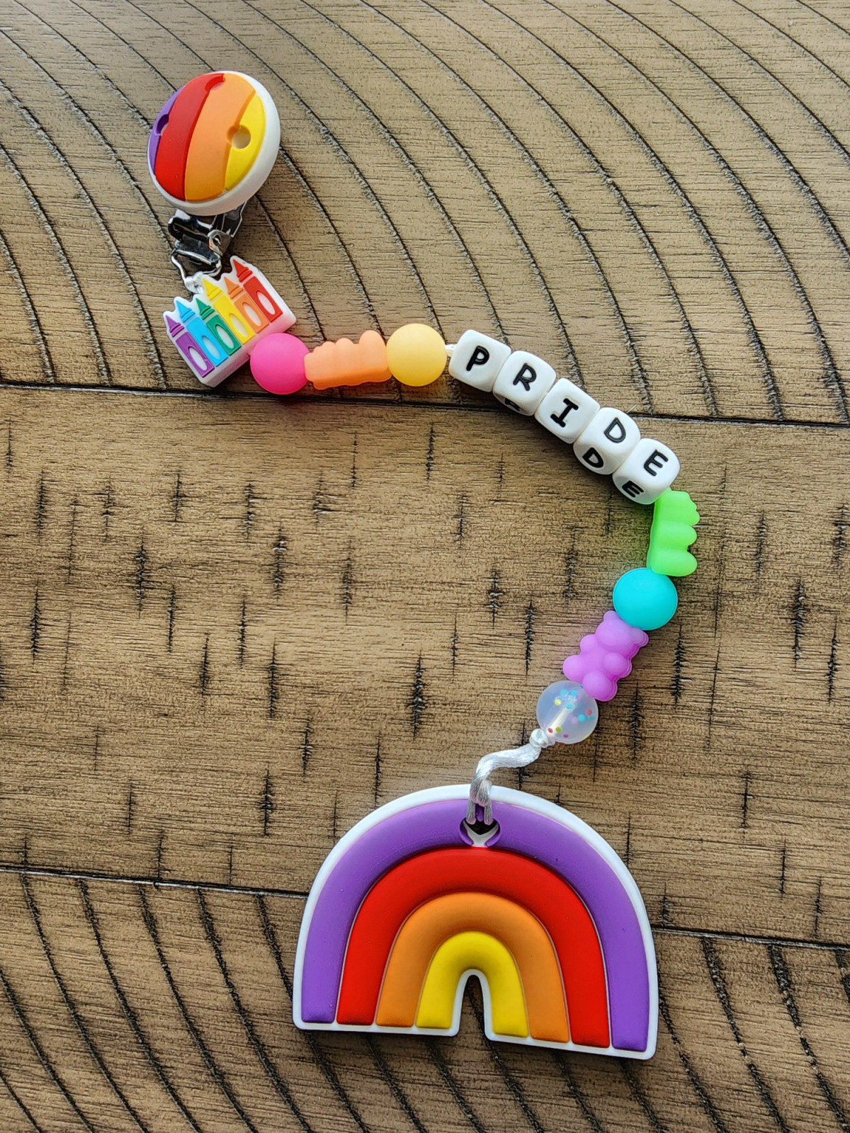 Pride Teether clip with glow in the dark rainbow gummy bear beads