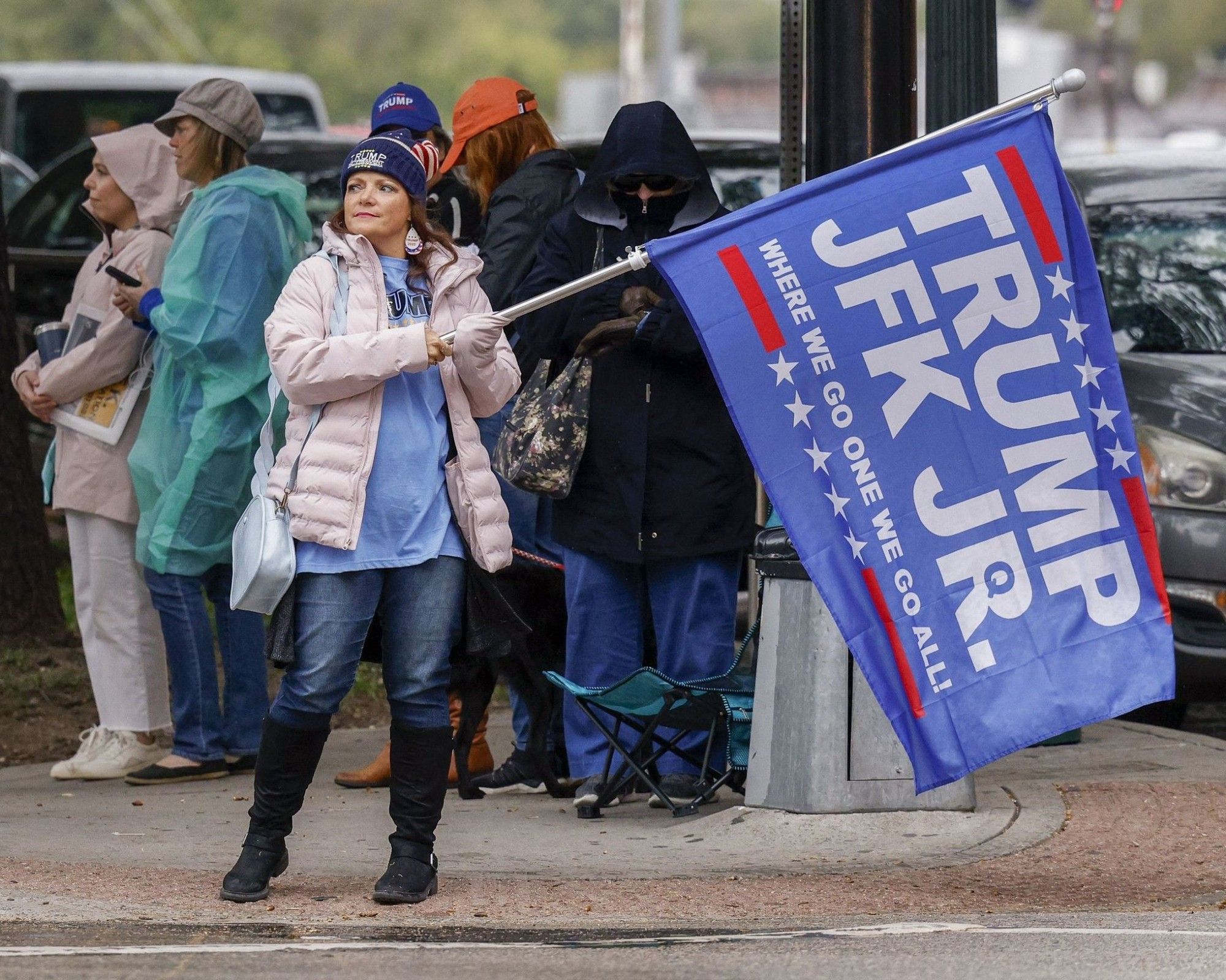 Photo of QAnon dipshit with a Trump/JFK Jr. flag at Dealey Plaza in Dallas. (Elias Valverde II/The Dallas Morning News/TNS)