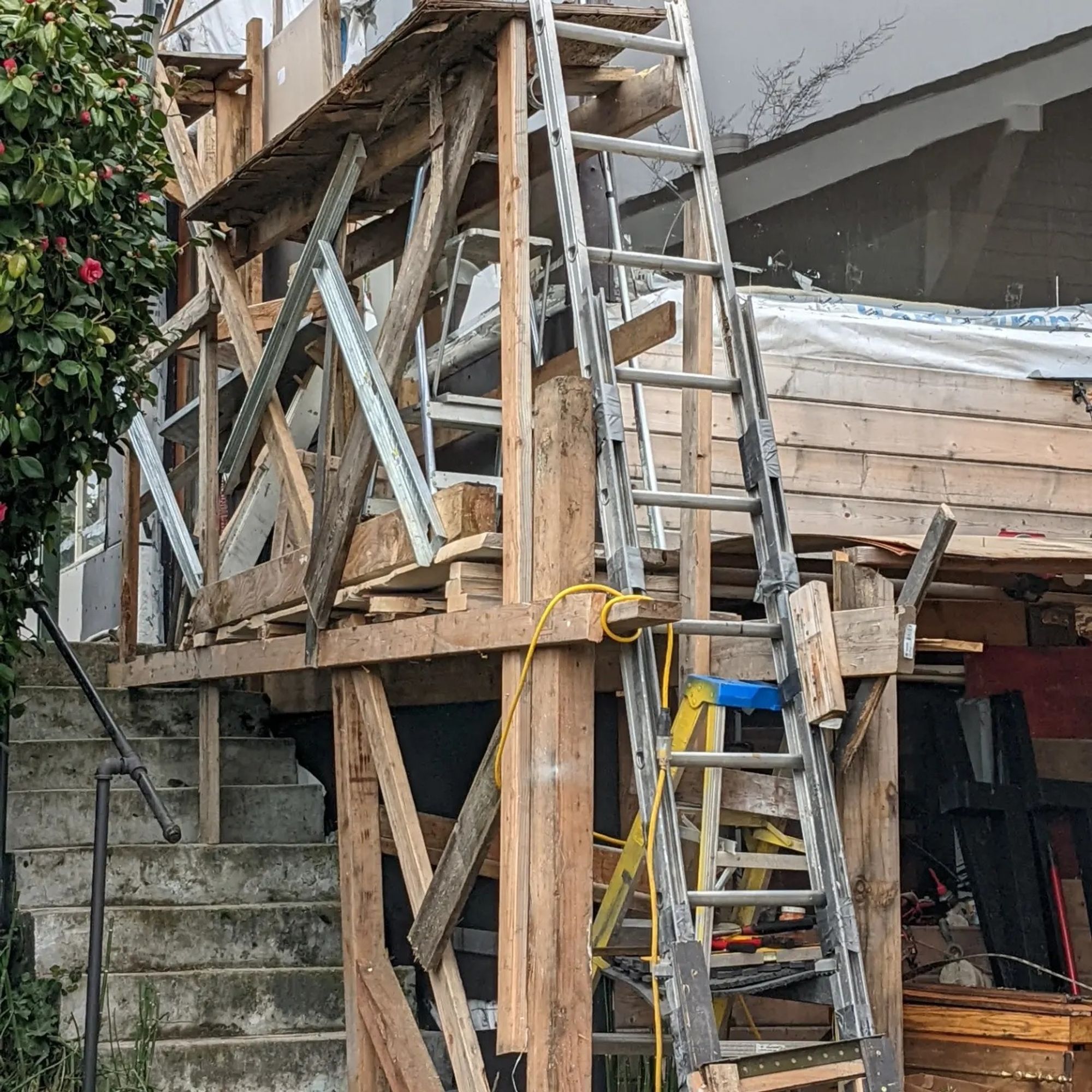 A ladder that's just ladders and pieces of strut taped together. Also scaffolding and unsafe extension cord pictured.