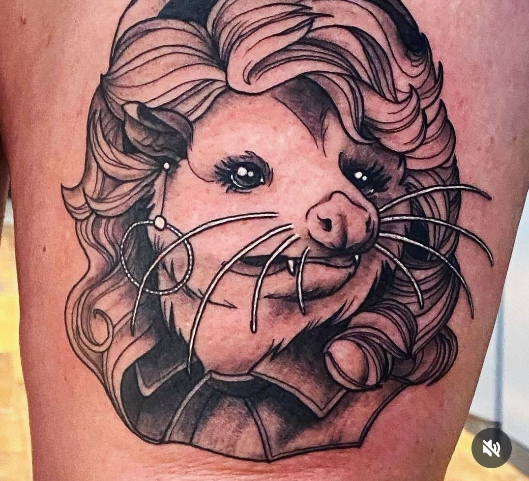 A tattoo of a possum head and a Dolly Parton wig by selajudetattoos