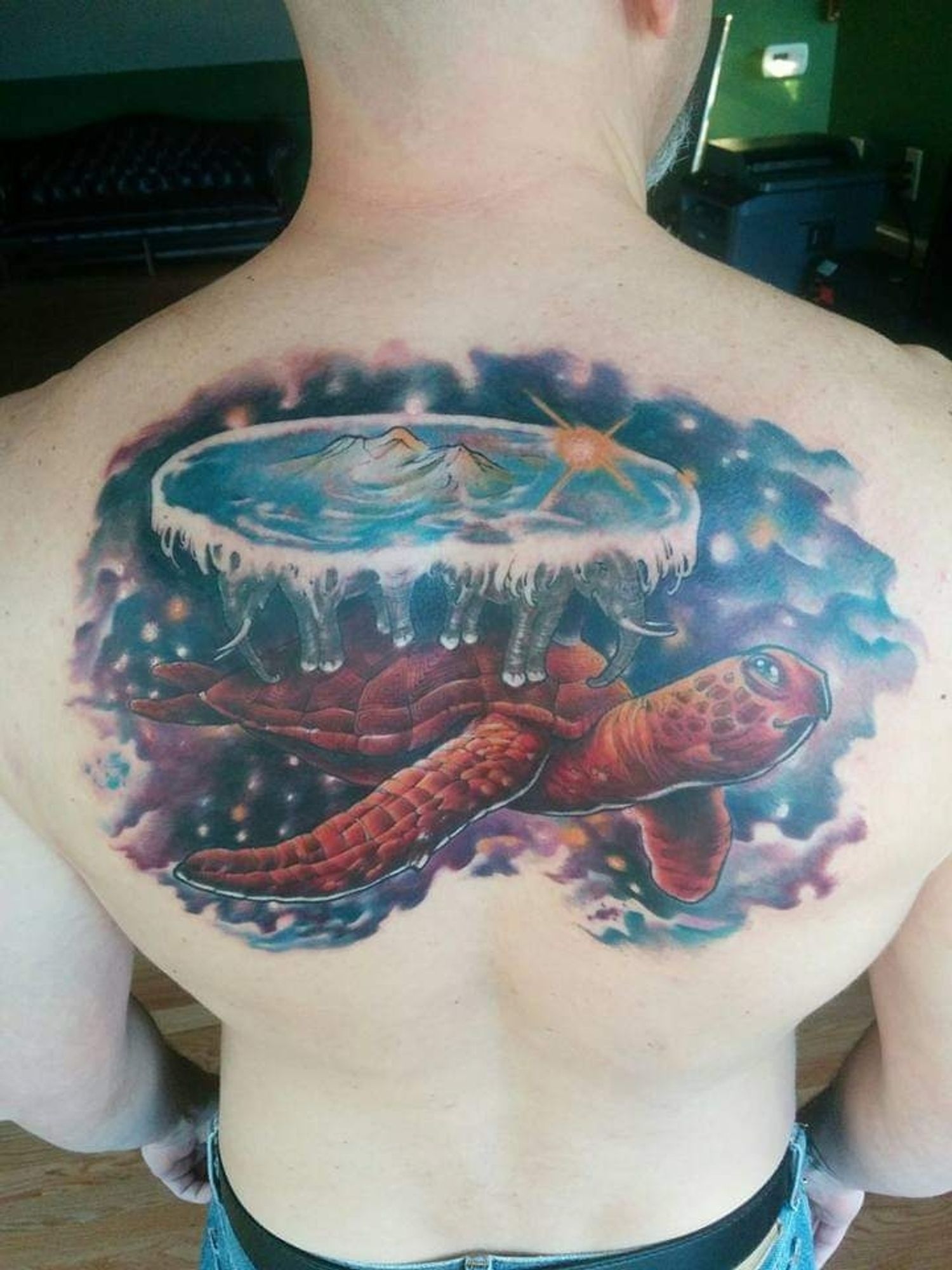 A back tattoo. The Great A'Tuin with the Discworld on her back.