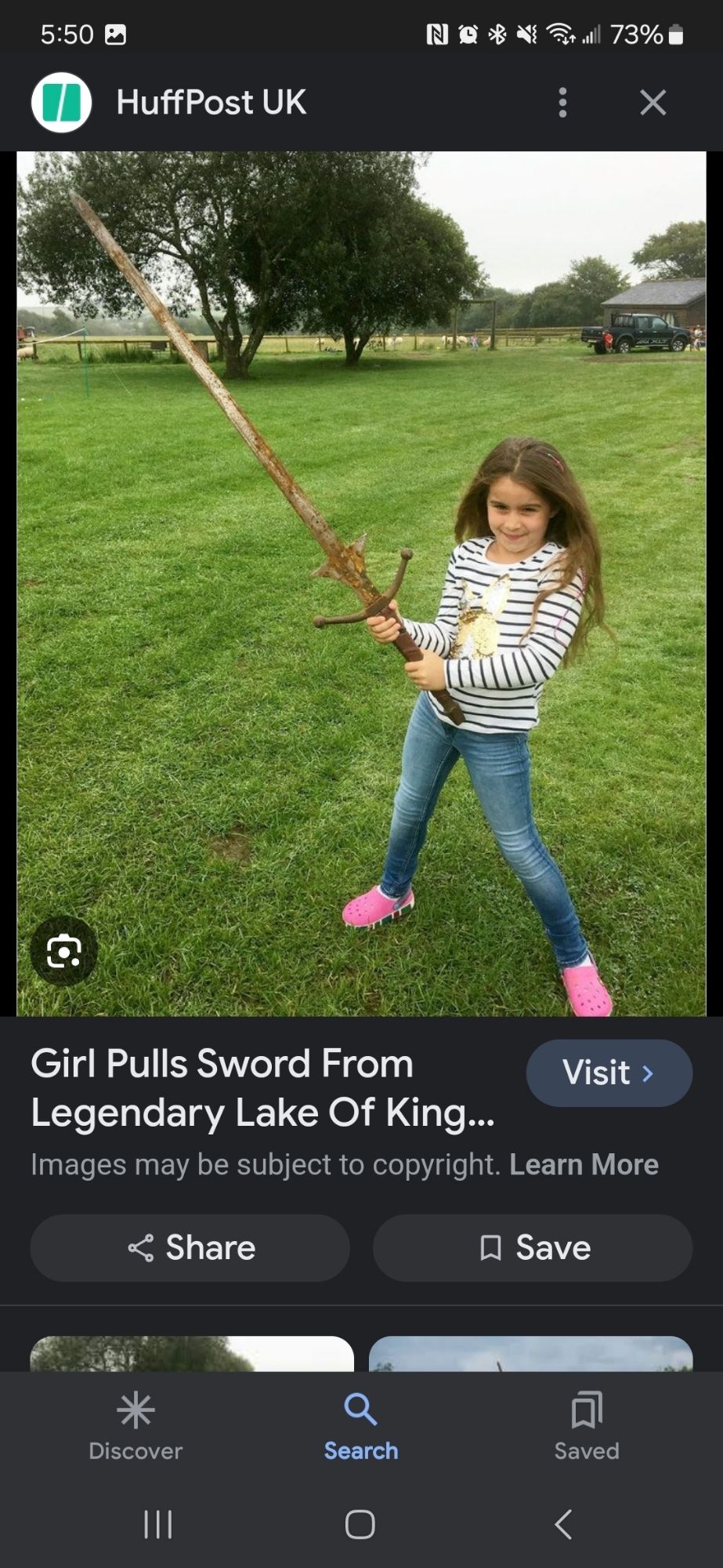 A girl to be about 8 years old wearing blue jeans and pink shoes with a striped shirt holding a giant fucking claymore sword. Headline reads girl pulls sword from legendary lake of King Arthur