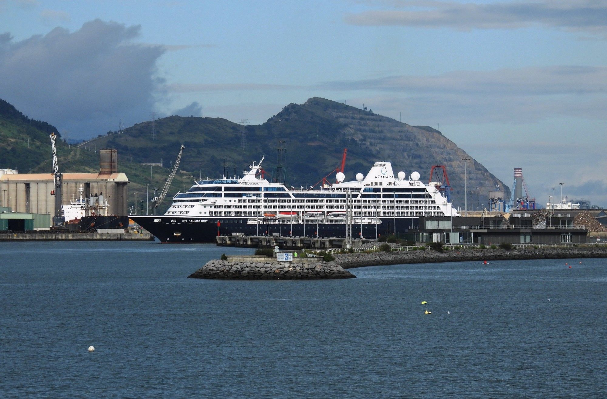 The cruise liner Azamara Quest sailing through the breakwater to dock in Getxo.