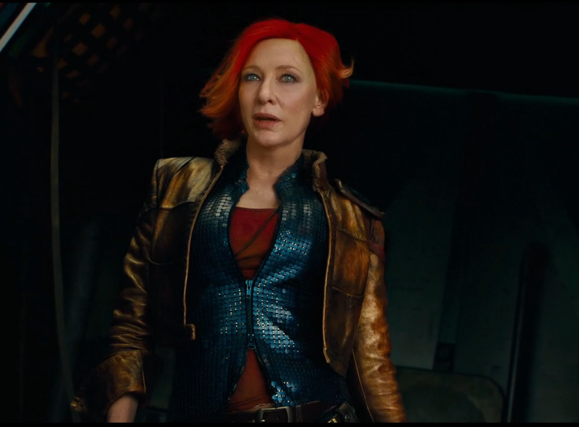 Cate Blanchett with bright red hair and a cropped brown leather jacket in Borderlands