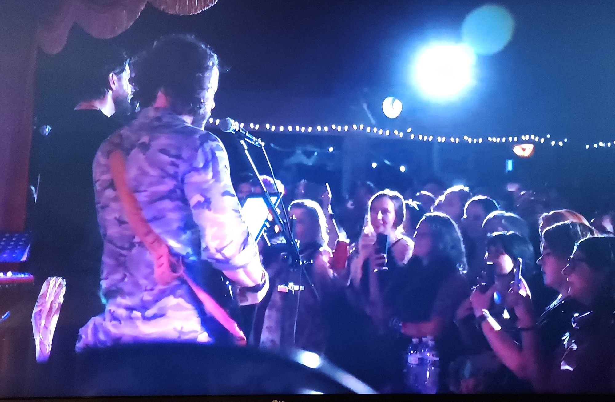 Camera angle from behind Jensen and Steve, showing the crowd