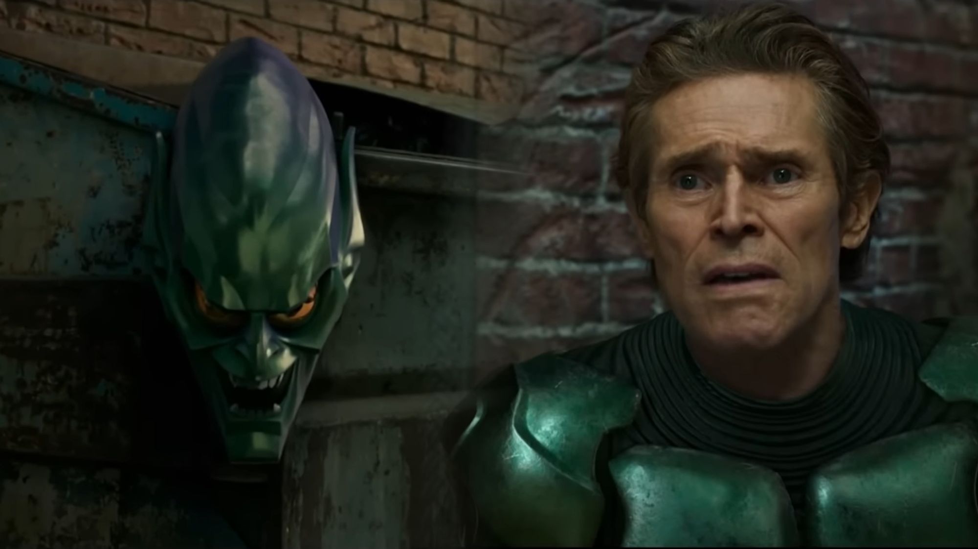 Willem Dafoe as green goblin staring at his mask, disconcerted