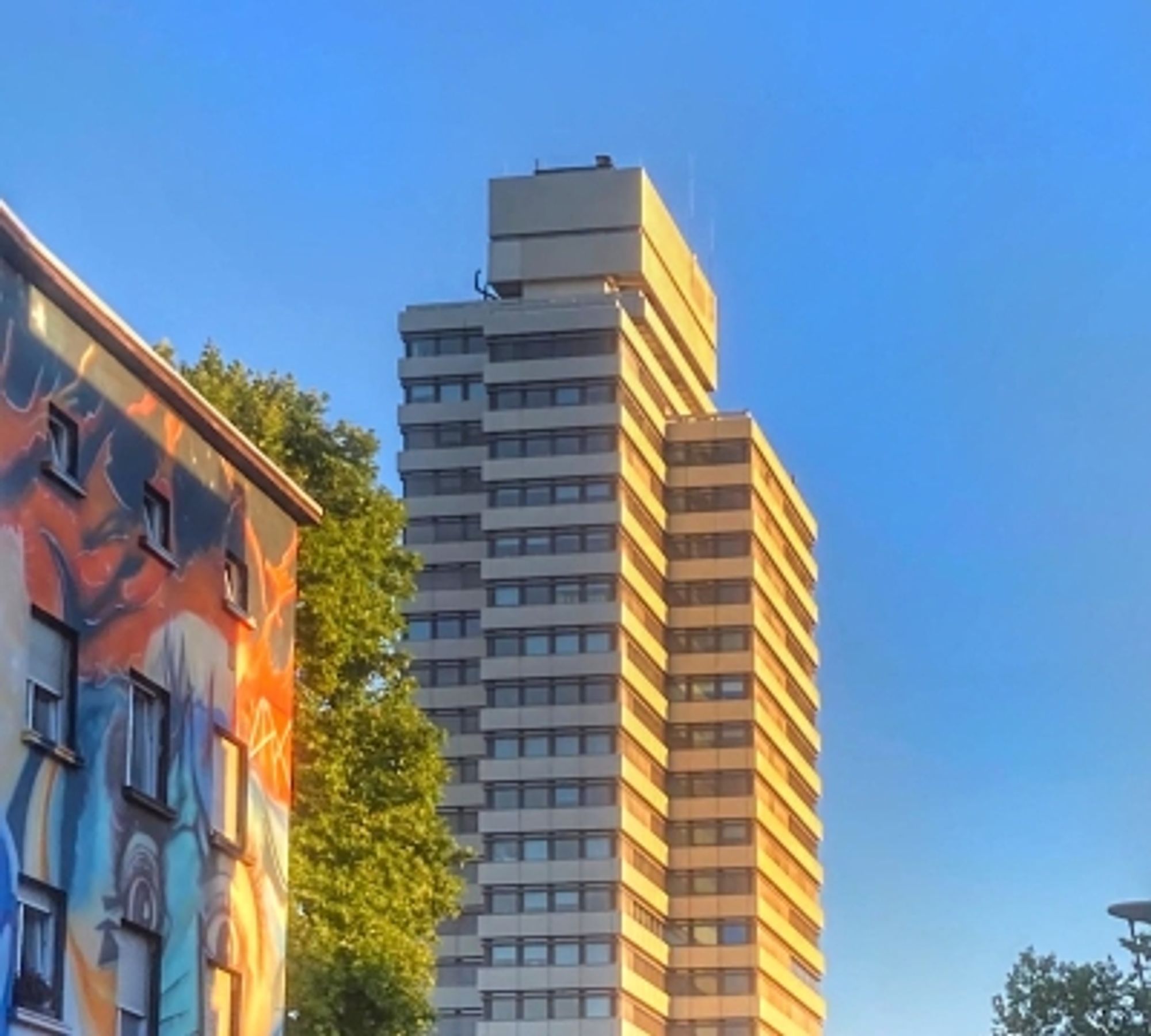 Kaiserslautern Mayor's Office, a 22 floor, 85 meter high concrete tower, in the evening sun so the concret looks yellow.