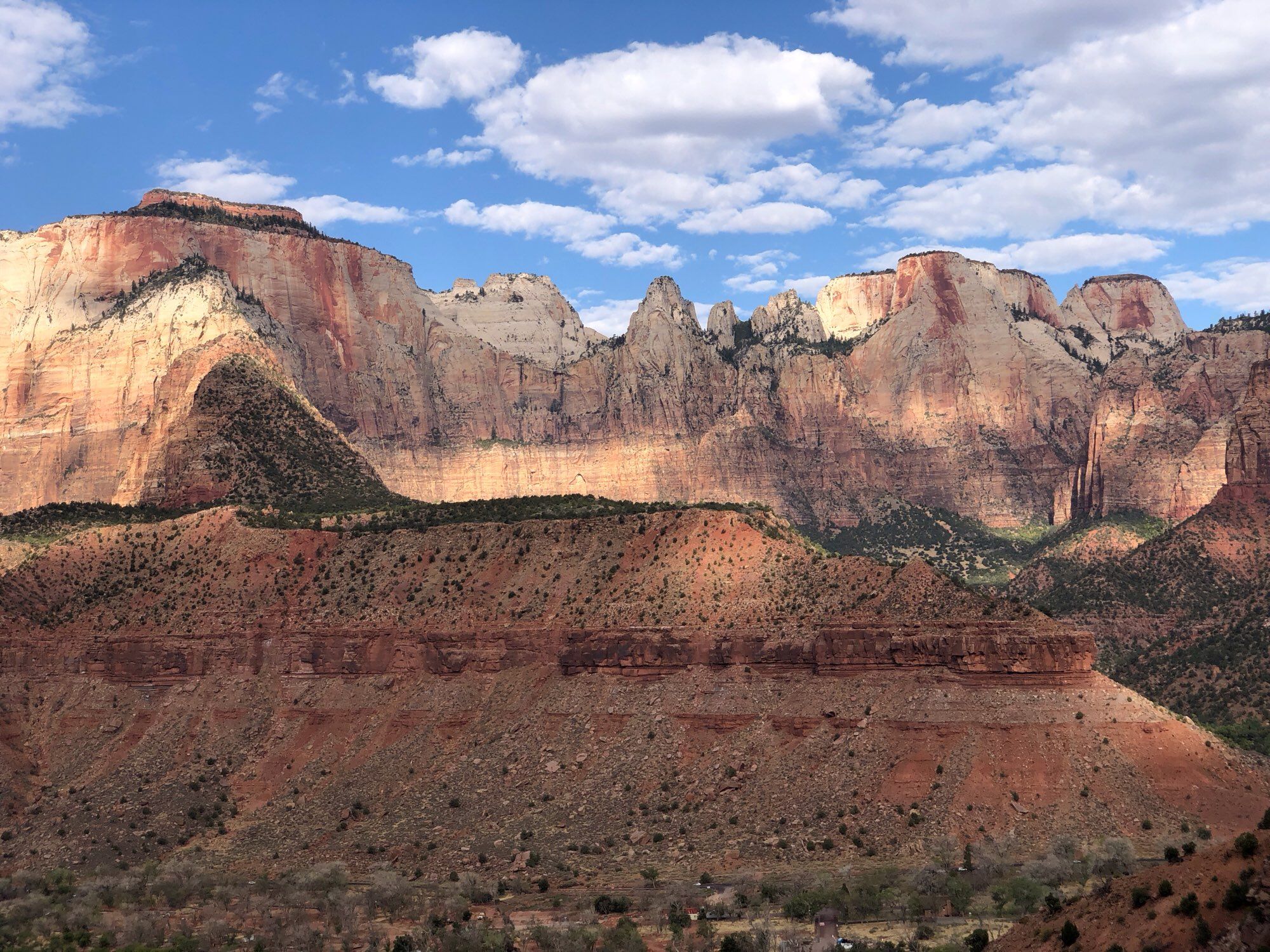 A view from Watchman’s trail in Zion National Park. This is looking across a canyon at some massive cliffs made up of multi-colored sandstone