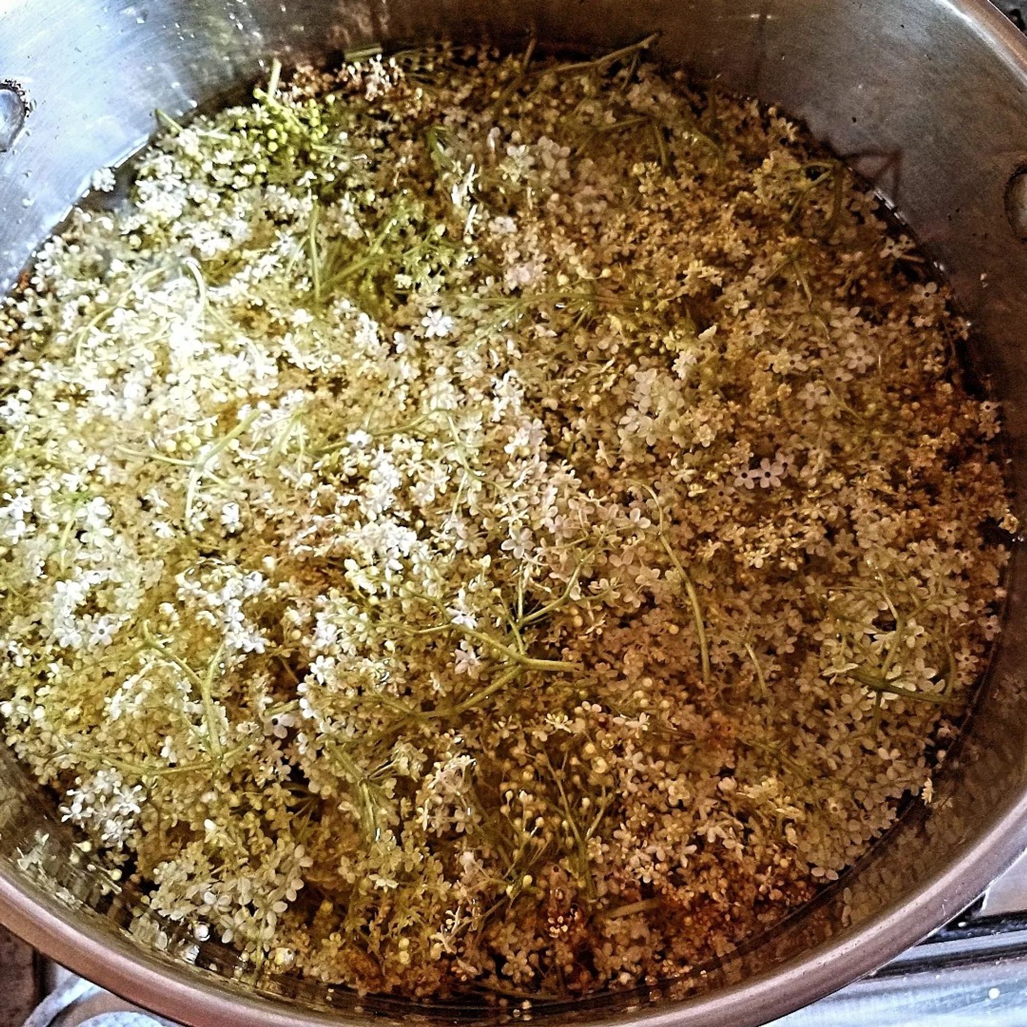 Pan of flower heads in syrup solution