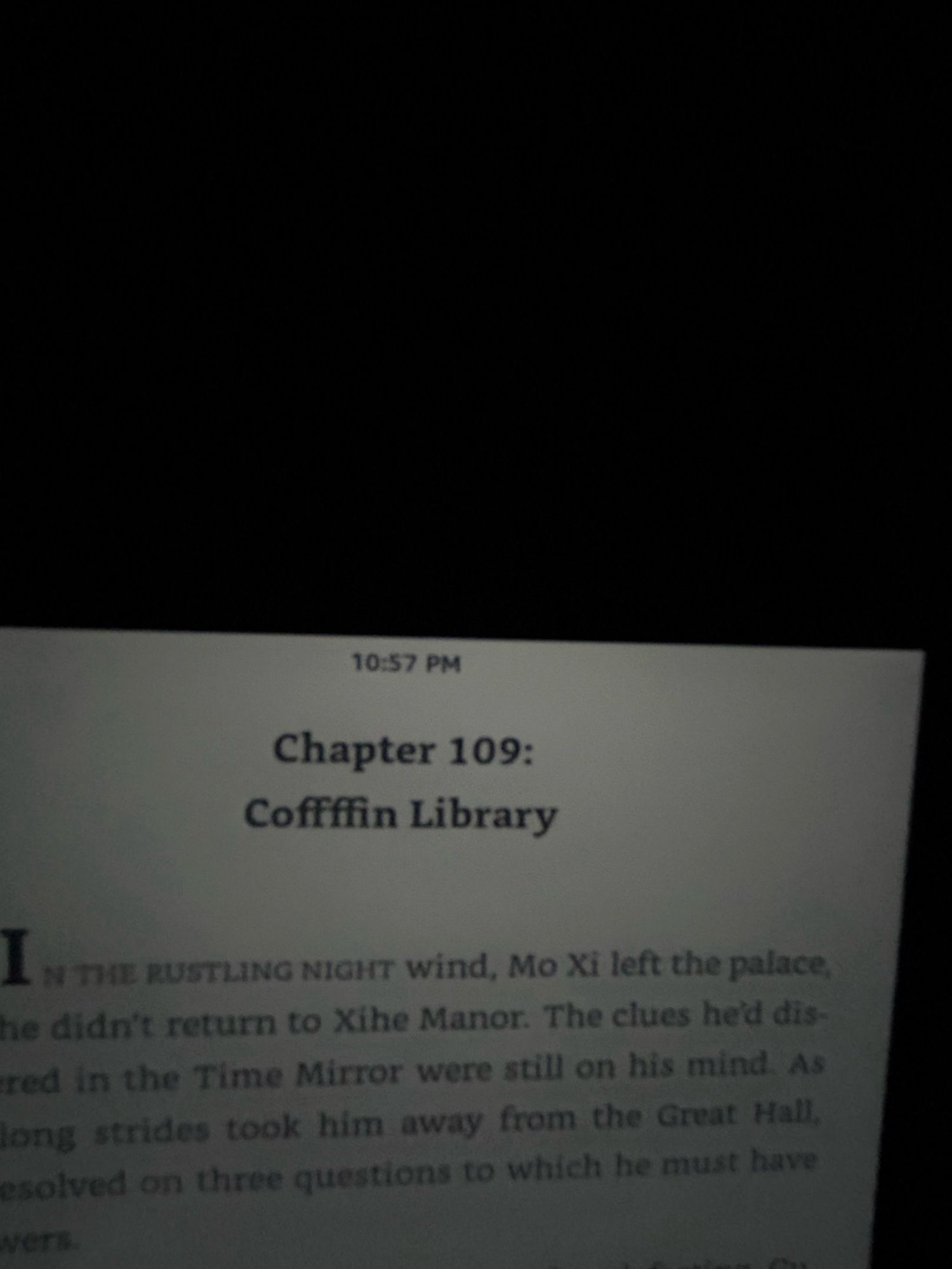 Terrible dark photo of half a kindle screen, showing the text: “chapter 109: Coffffin Library” yes with four Fs. At least four Fs.