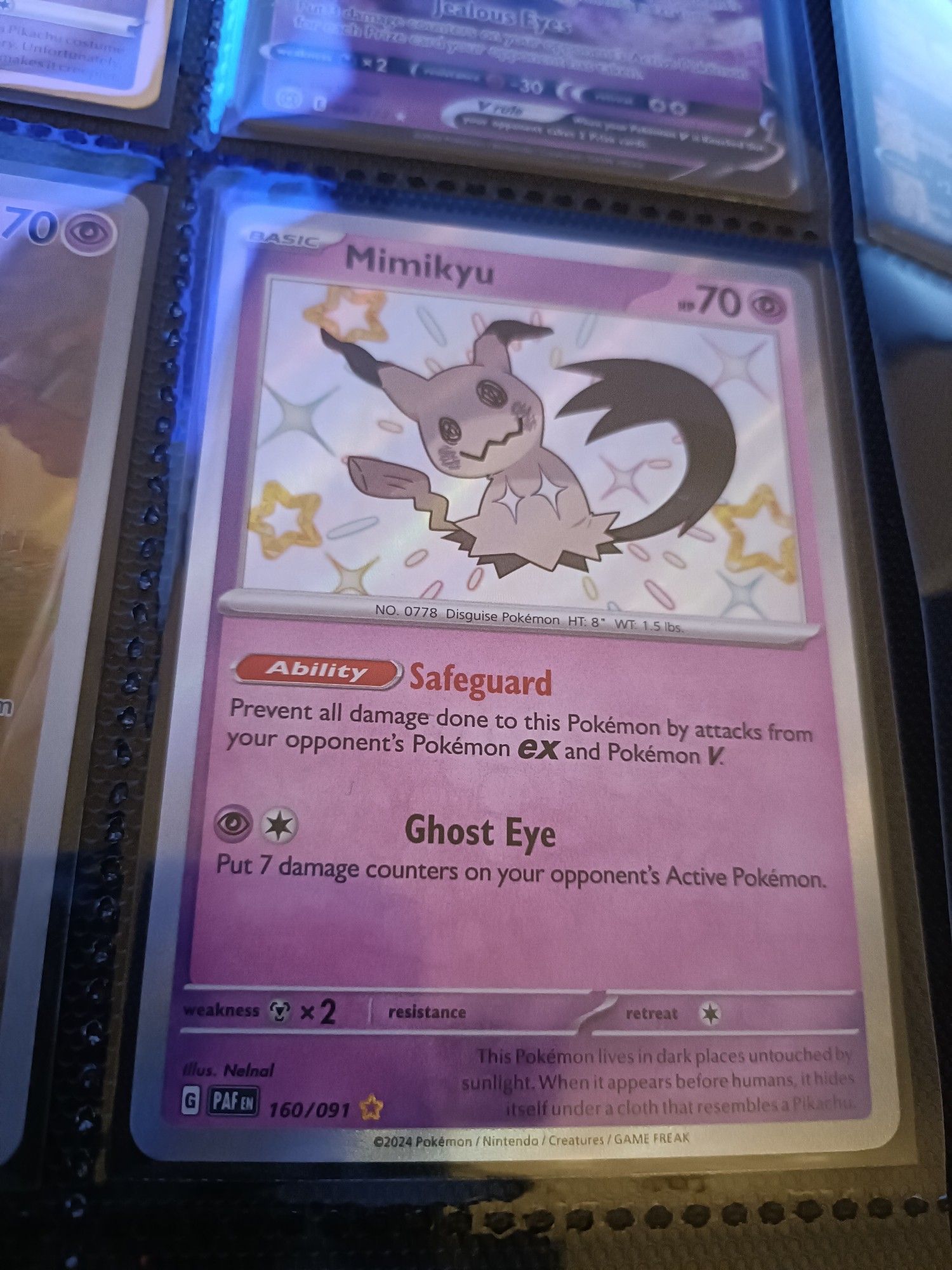 A Pokemon Card featuring a shiny Mimikyu