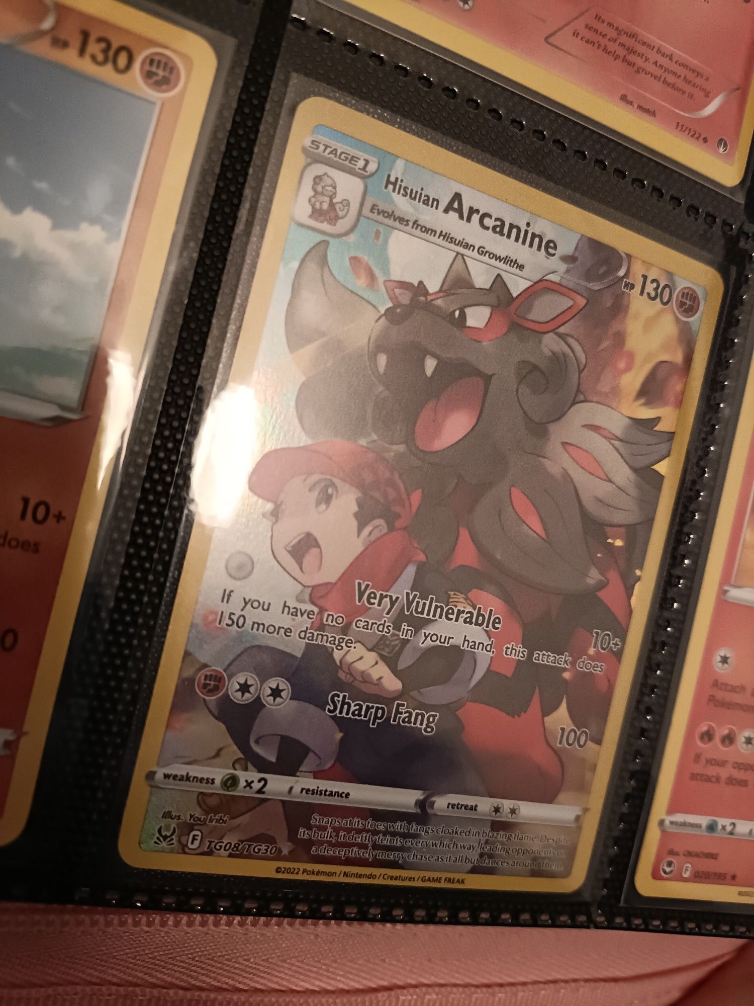 A Pokemon Card featuring Hisuian Arcanime and a trainer