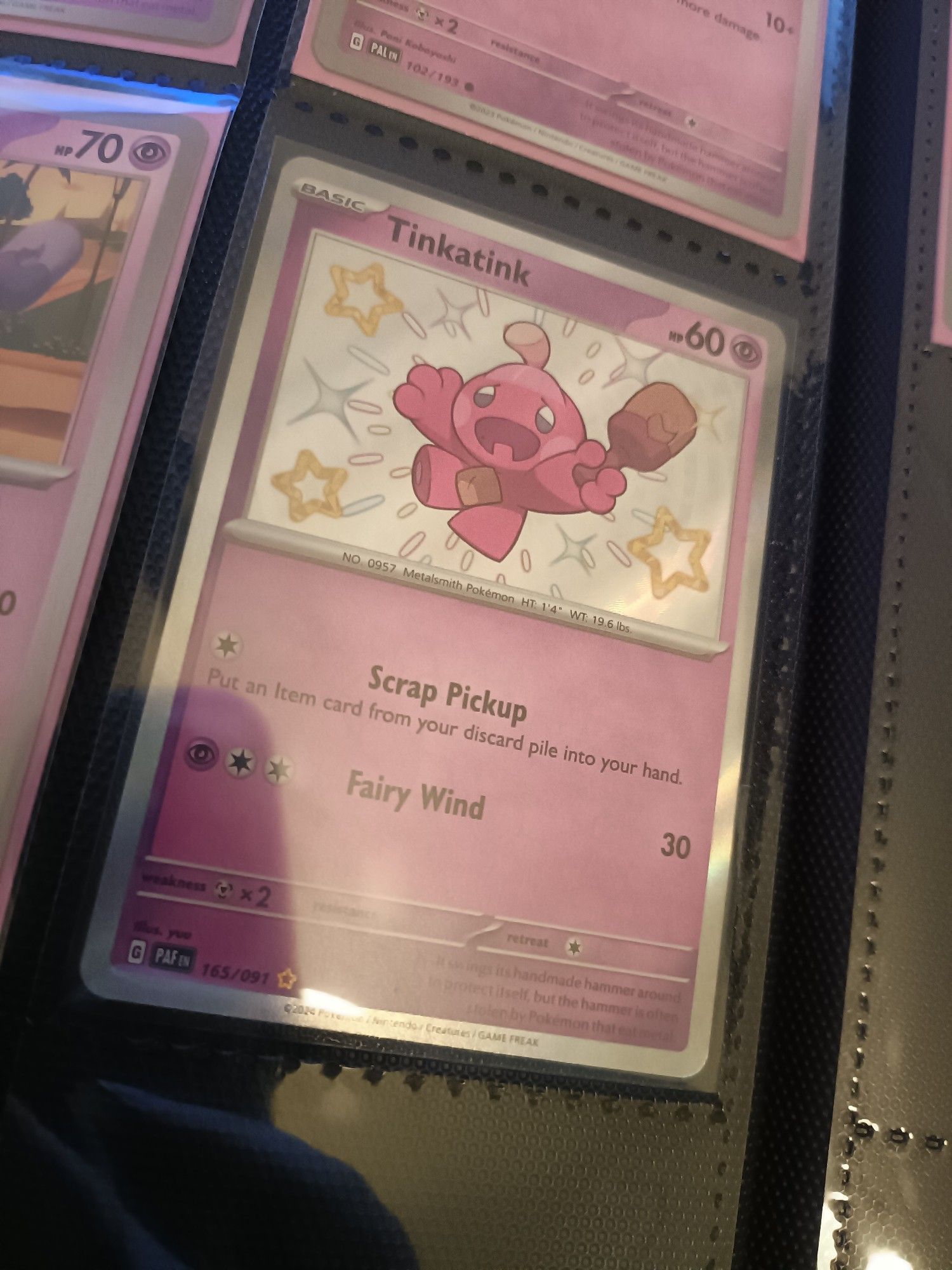 A Pokemon Card featuring a shiny Tinkatink