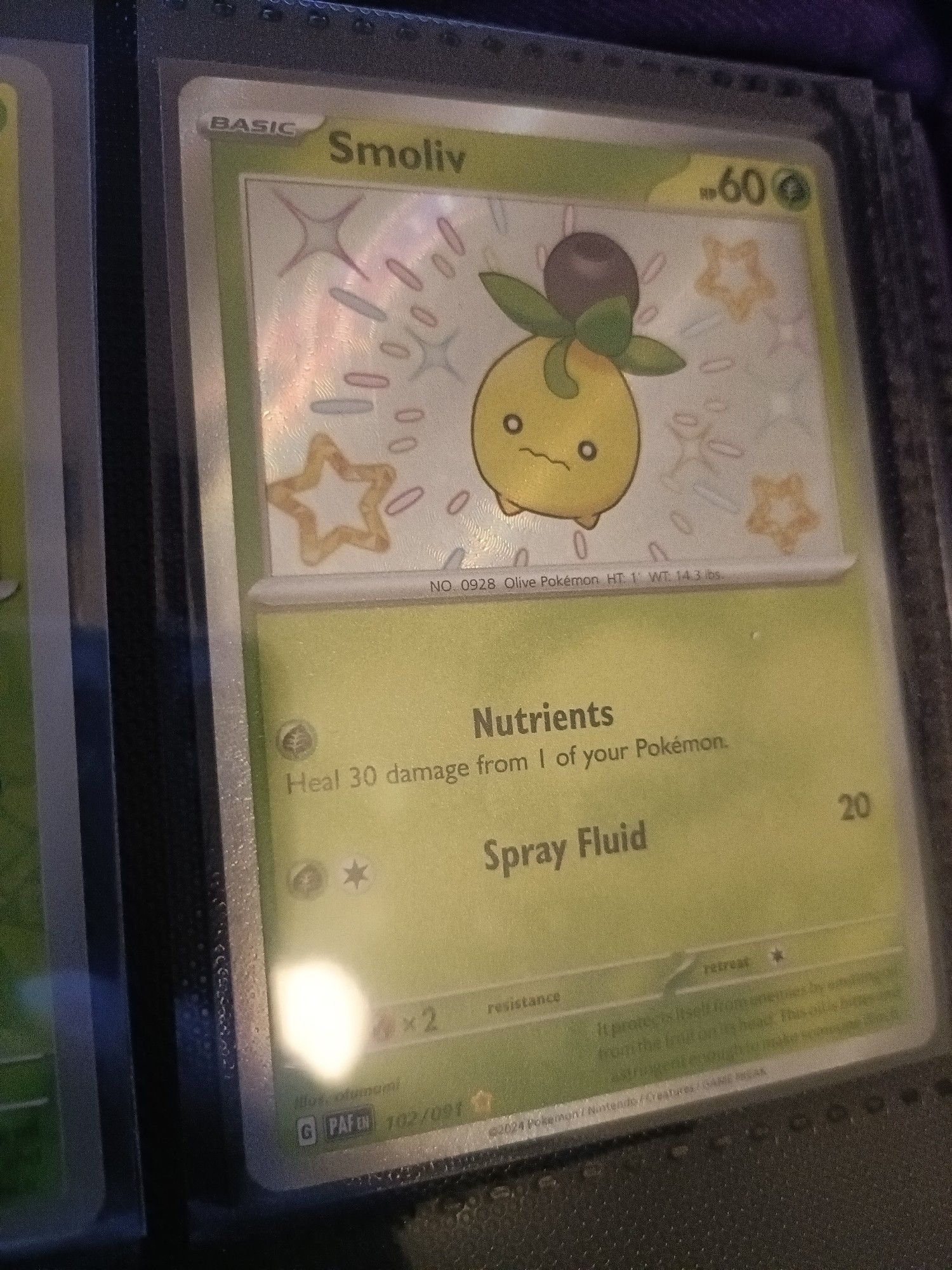 A Pokemon Card featuring a shiny Smoliv