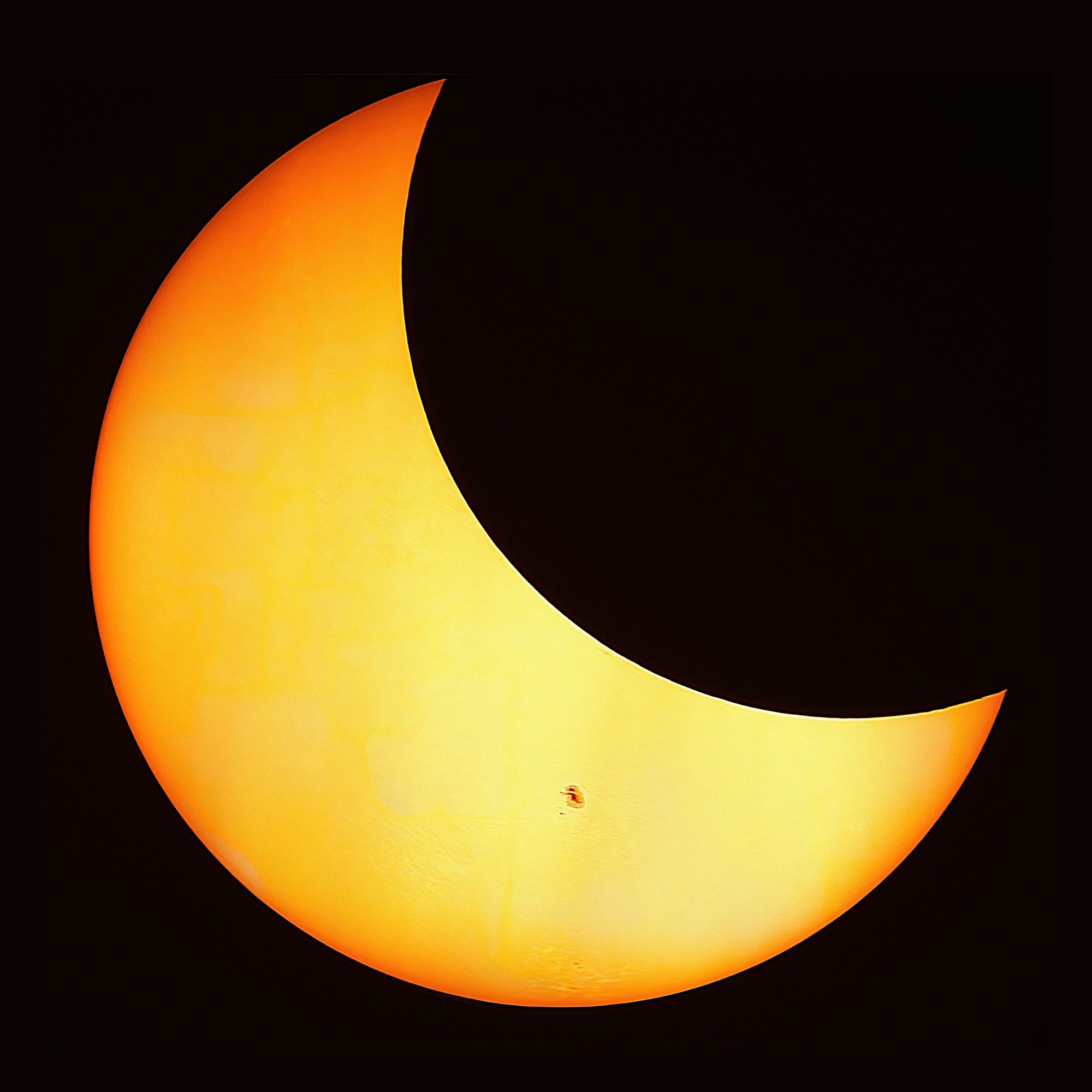 Partial solar eclipse through clouds on October 14, 2023, shot from Bloomington, IN.