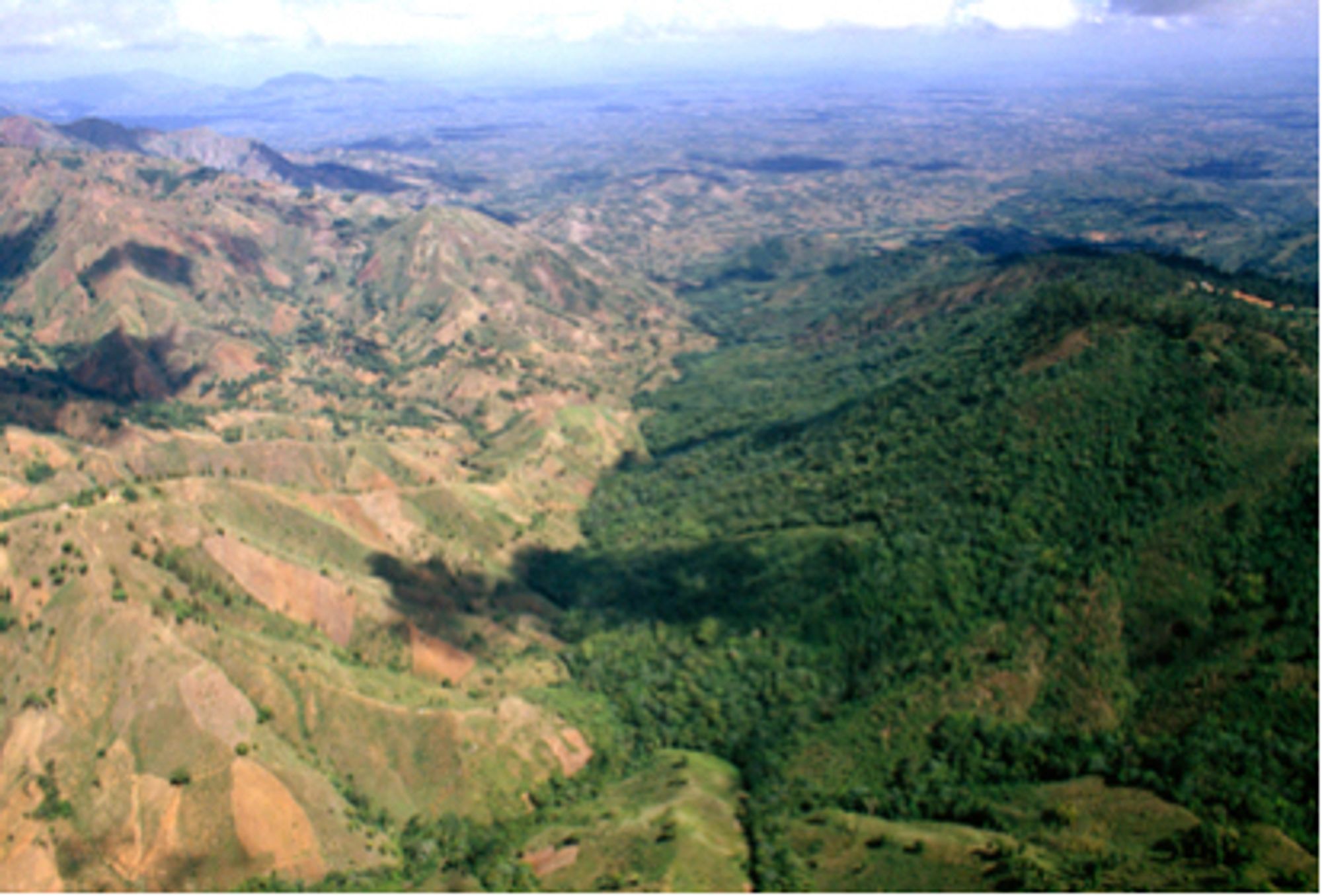 Aerial photo of Hispaniola, Haiti on the left, Dominican Republic on the right. Haiti is largely deforested, Dominican Republic is heavily forested. 1987, National Geographic.