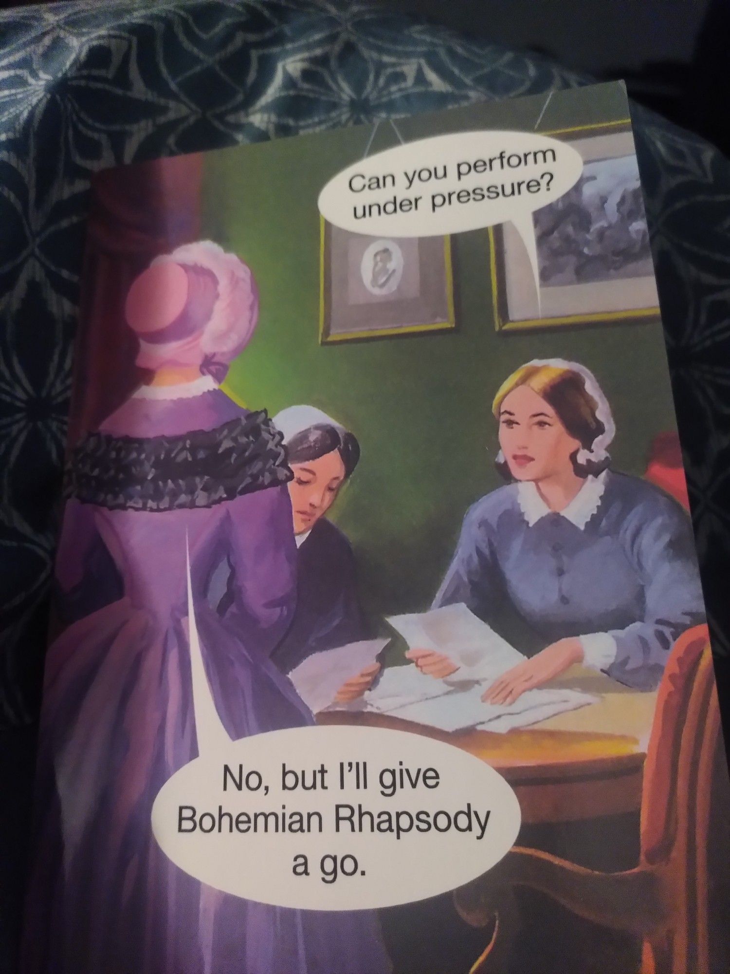 Humorous birthday card. Illustration of three mid-Victorian style women in an interview-type situation. One asks 'Can you perform under pressure?' Reply is 'No, but I'll give Bohemian Rhapsody a go.'