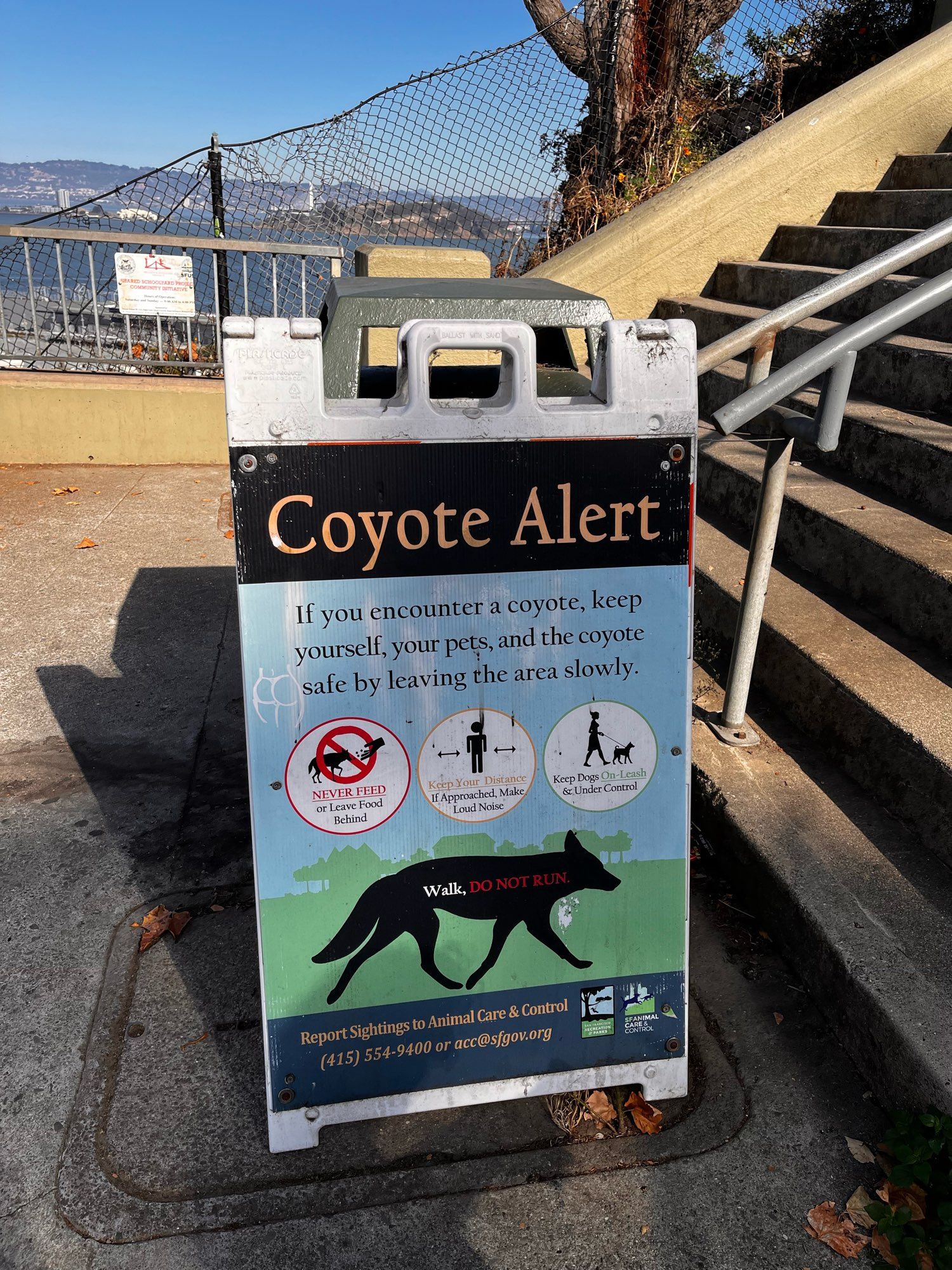 A signboard that says “Coyote Alert”, with a silhouette of a coyote and various warnings.