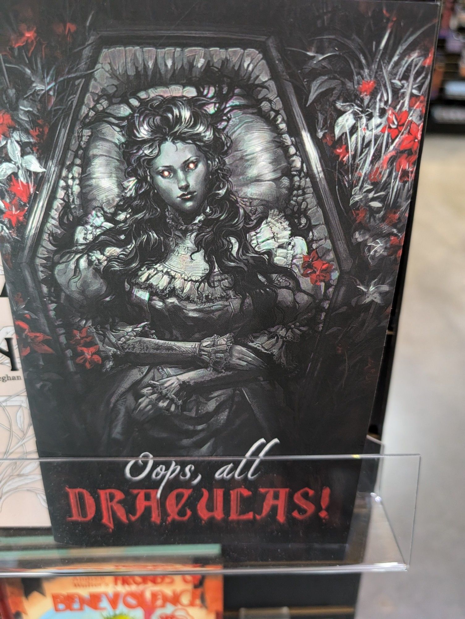 A cover of a role playing game called oops all Draculas depicting a vampire lady lying awake in a coffin