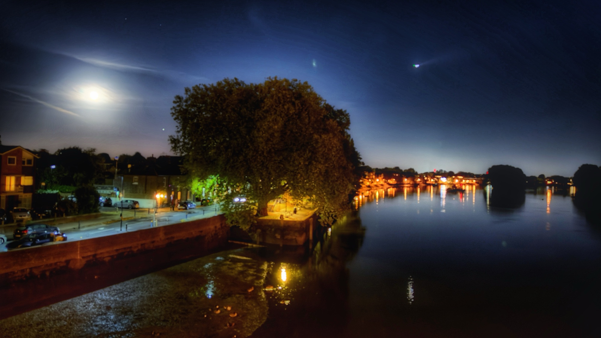 Night sky with a full moon over the river Thames in London. 