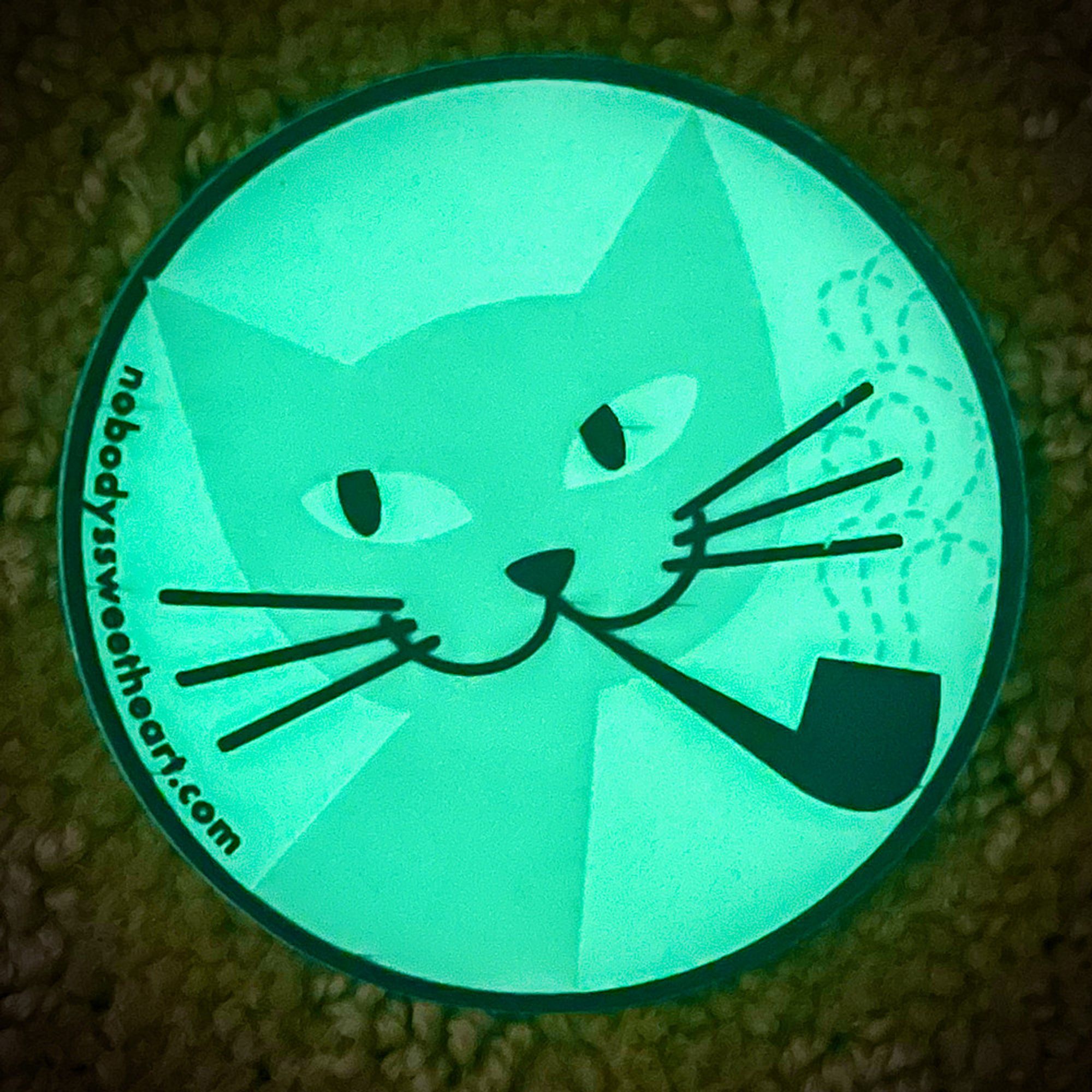 glow-in-the-dark sticker of a cat smoking a pipe, looking askance