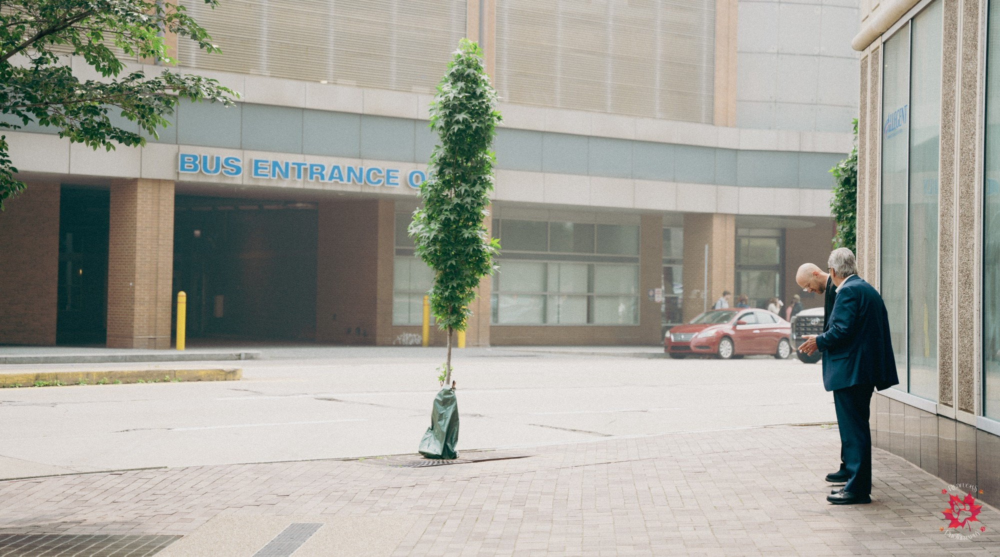 Street photography of two businessmen standing outside of Anthrocon's Westin Hotel