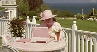 Authoress Mary Fisher sitting on a lanai with a pink Zenith Laptop.