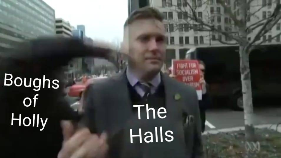 A meme with Richard Spencer (right) labeled "The Halls" and the incoming fist of an antifascist (left) labeled "Boughs of Holly."