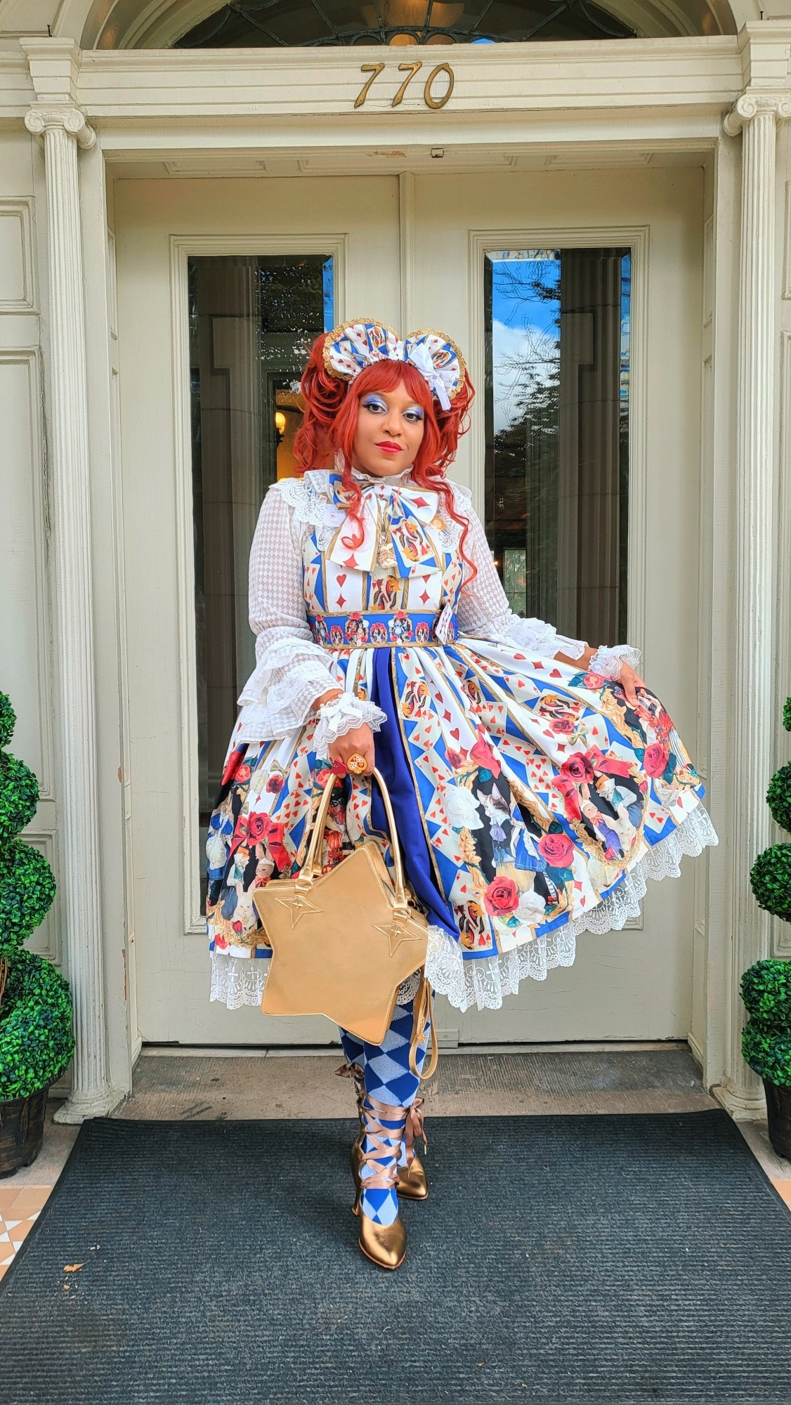 Milkcircus wearing a white & blue dress Alice in Wonderland themed dress by Royal Princess Alice. They're also wearing a diamond pattern white hime sleeve blouse, blue & silver diamond over knee socks, and gold boot heels.