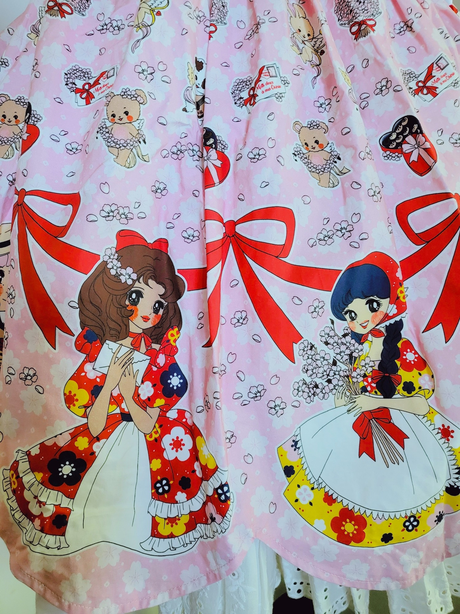 Close up of 2 of the girls wearing dresses in the border print.