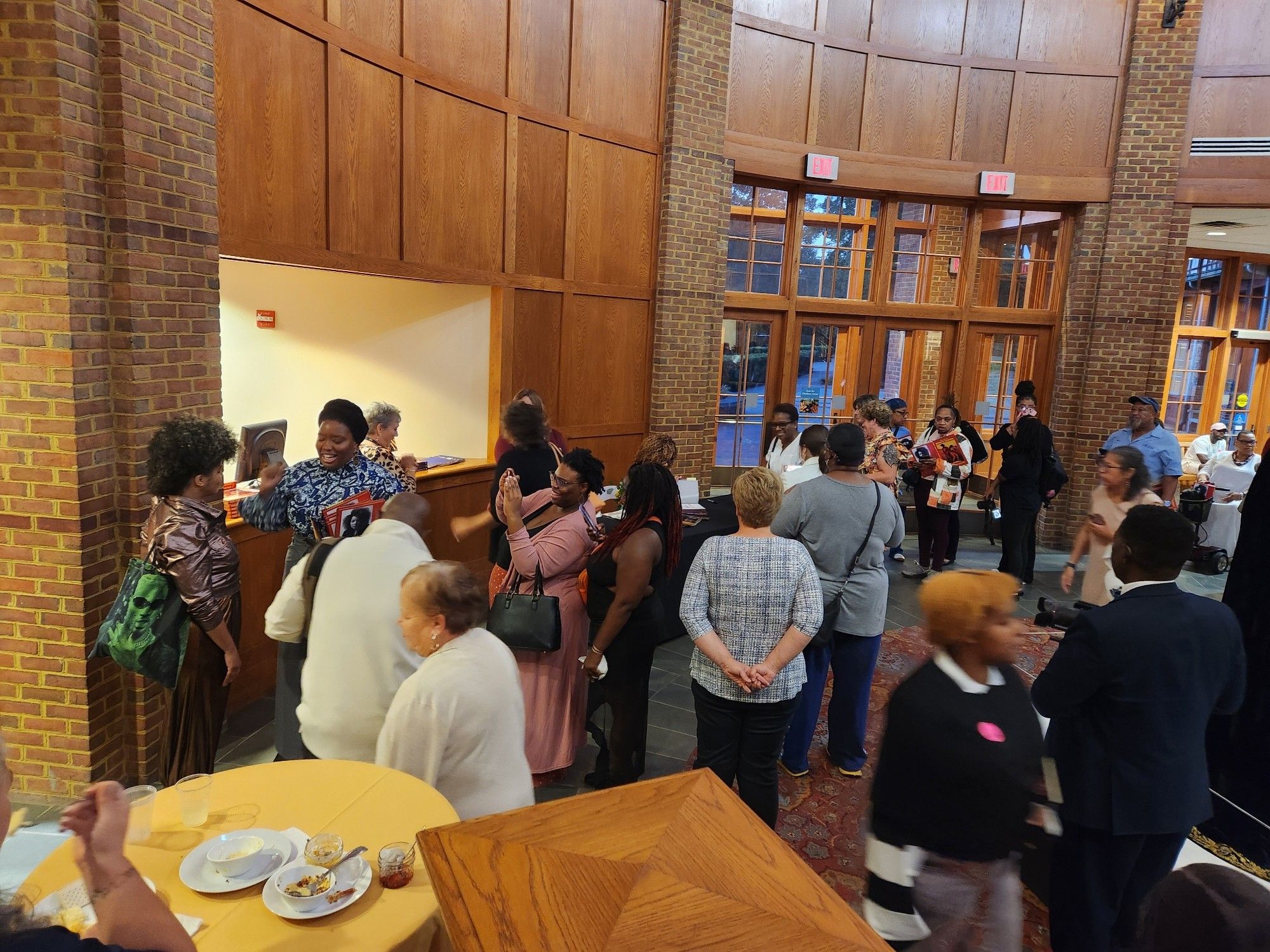 A large excited crowd lines up to talk to Ytasha Womack & Ruth Carter at the exhibit event at Jamestown Settlement on Oct 5 2024